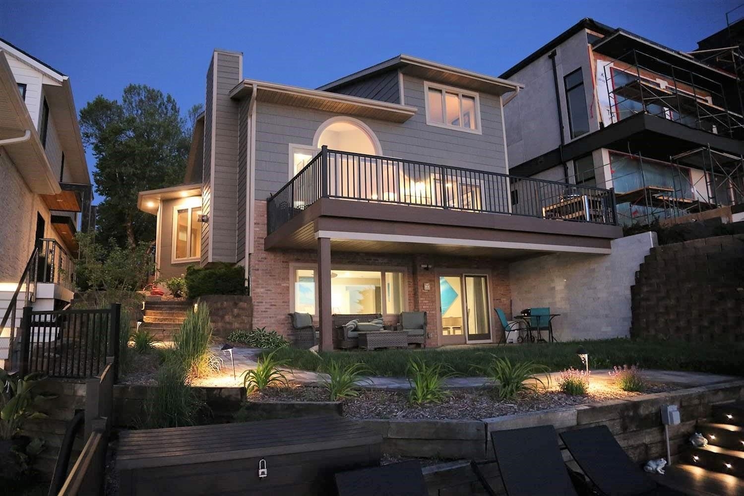 Peace, Tranquility & Picturesque Sunset Views! Located on 45 feet of desirable West facing lakeshore frontage! Enjoy summer evenings on the lake using one of the multiple deck and patio options. This stunning home features 2 full master suites with panoramic views! The lower level suite includes modern updates and a walk-out to the deck & dock. The main level showcases vaulted ceilings, hardwood flooring, new carpet, and the 1st of 3 fireplaces. A total of 4 bedrooms and 4 bathrooms, this unique property has room for the whole family to enjoy life on the Lake! Call today to schedule your private showing.
