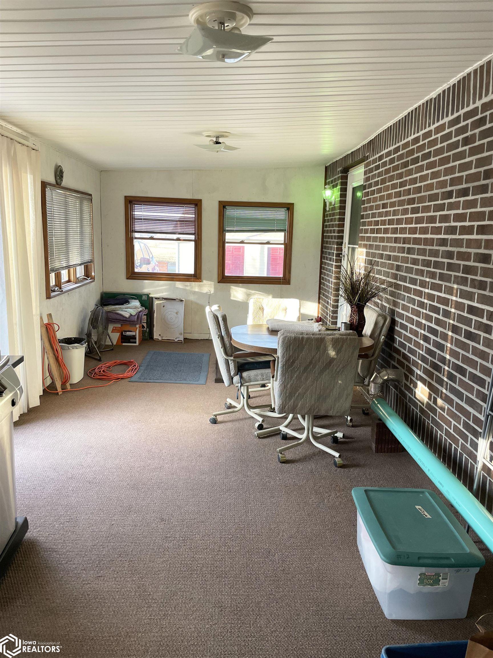 View of the enclosed back porch looking N.  This space offers a great place for relaxing on or entertaining.  Possibilities are endless for whatever you choose.