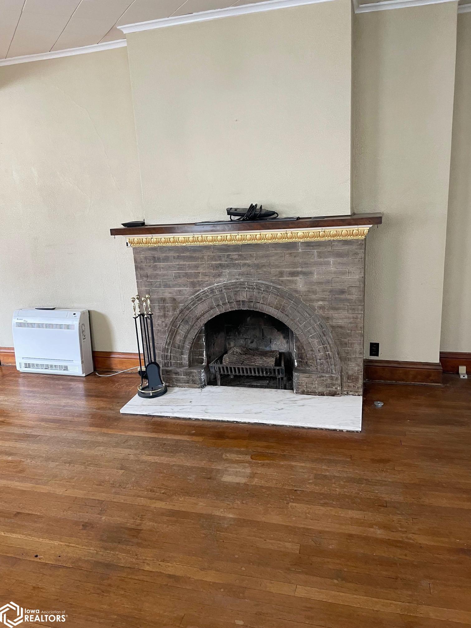 Another view of the wood burning fireplace located in the formal sitting room.
