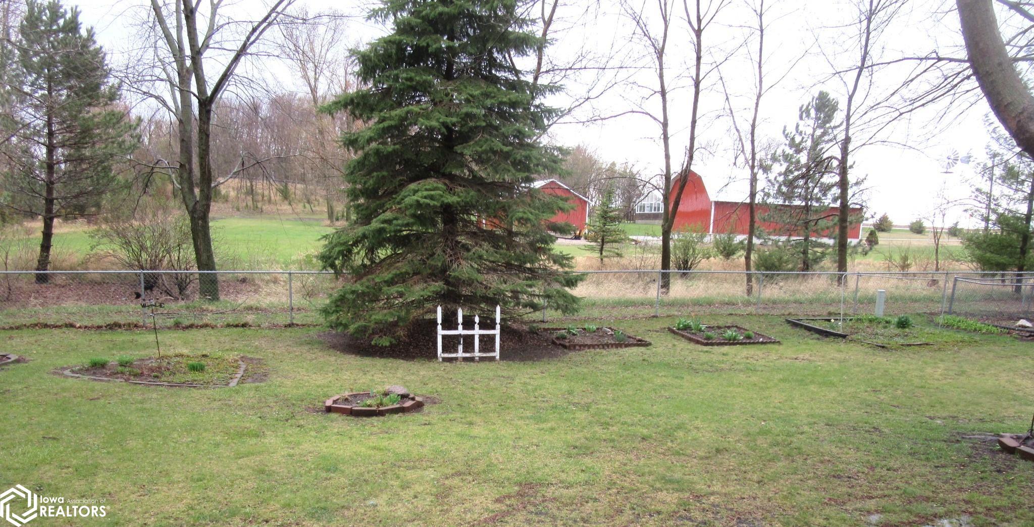 Raised Beds and mature trees.  Some of fence is chain link.