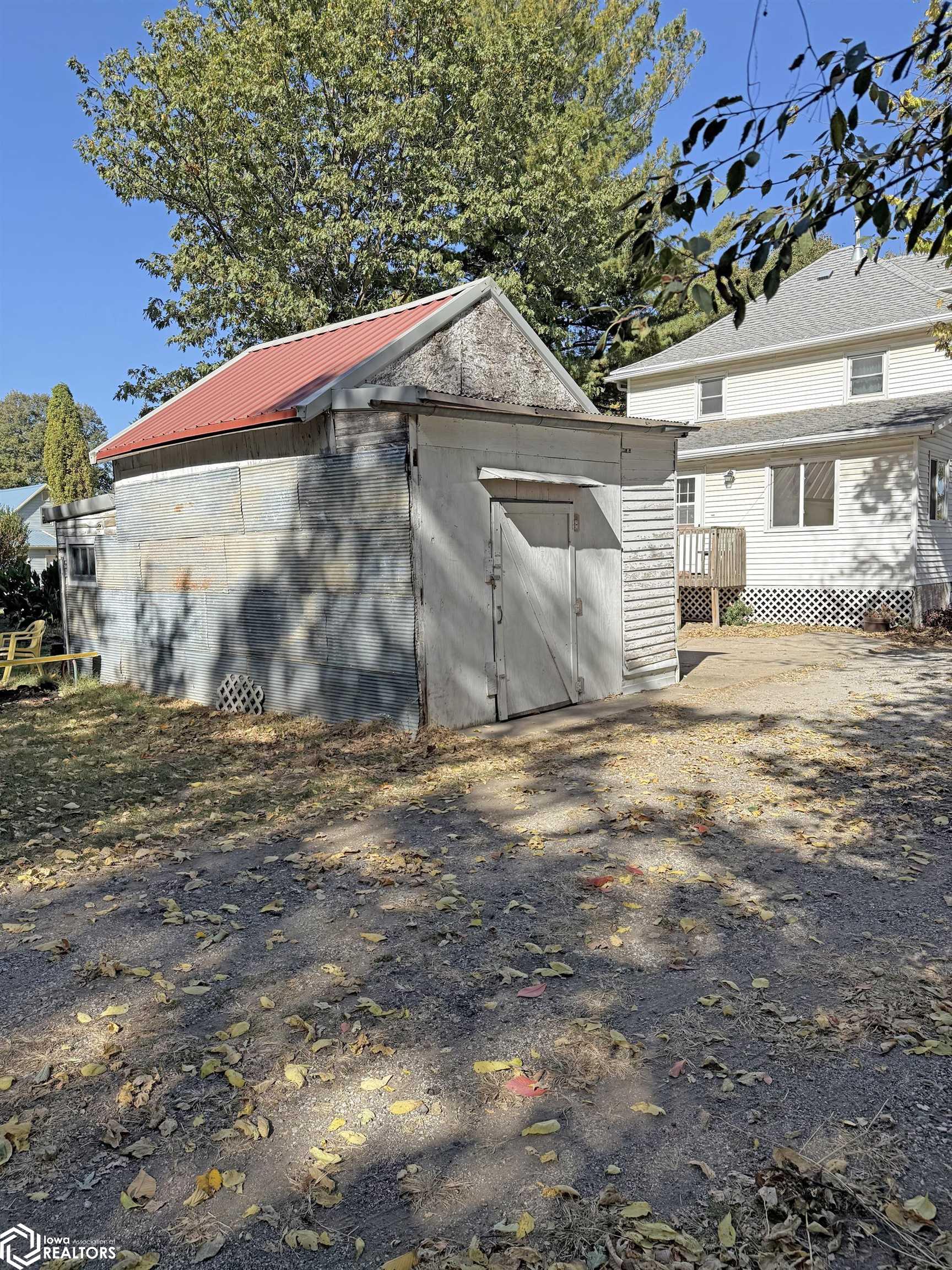 View of the detached garage looking NW.  The door would have to be changed to an overhead door to have access for a car.  Currently used as a large shed.