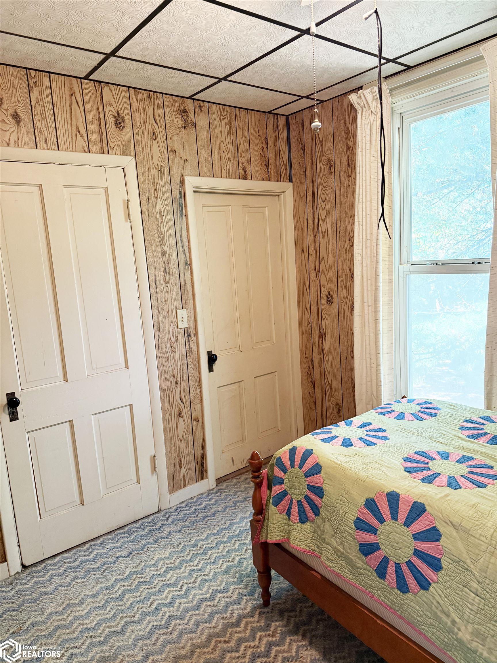 View of the main floor bedroom looking S.  The door to the left in the photo leads to the basement, and the other door leads to a closet.