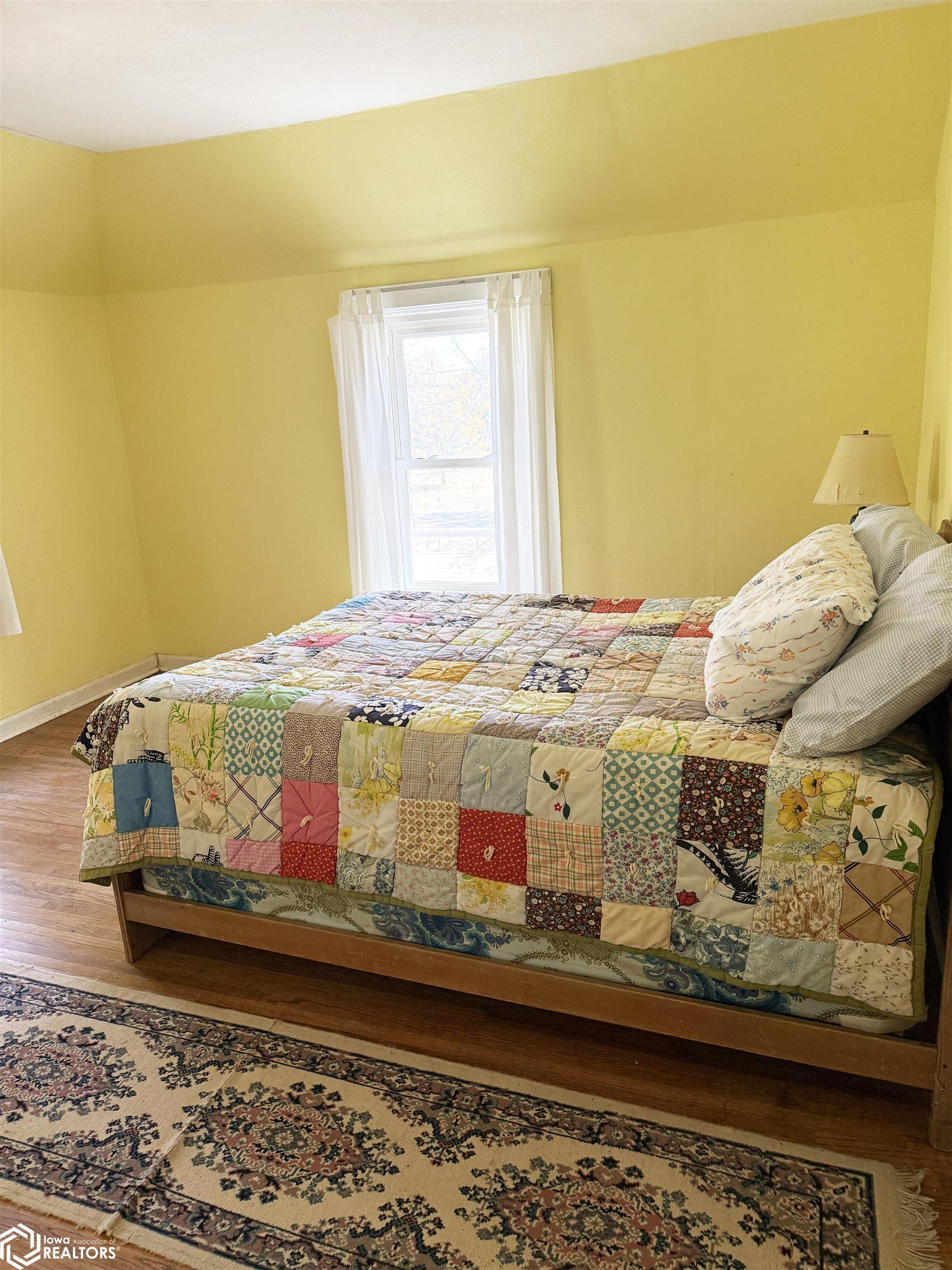 View of the large upstairs NE bedroom looking E.