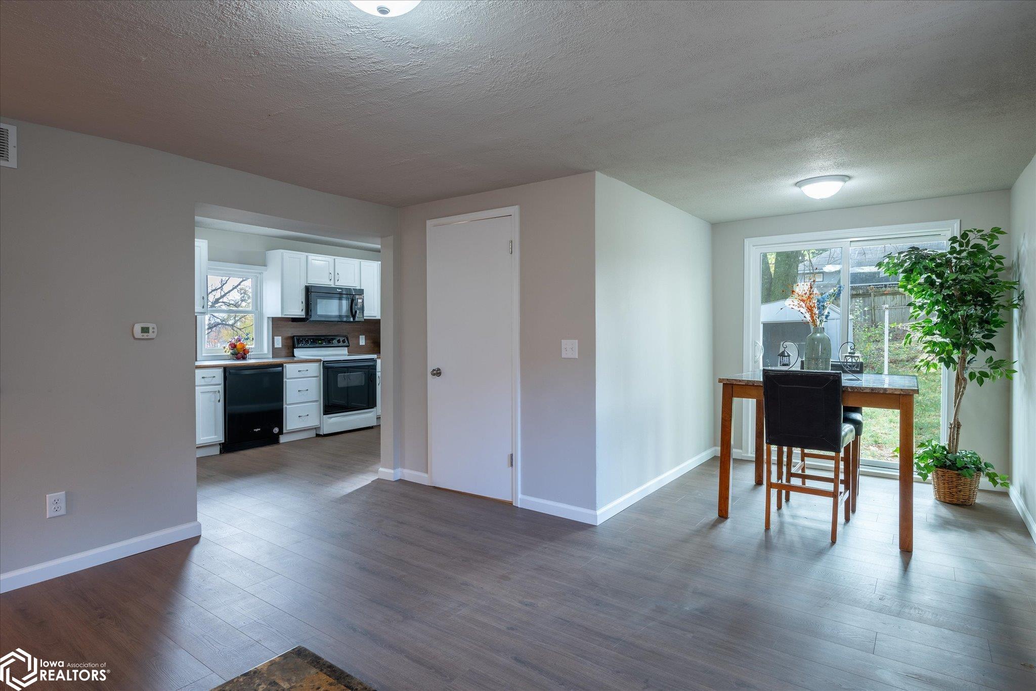 The living room is open to a dining area. It is an open layout with a lot of natural light.