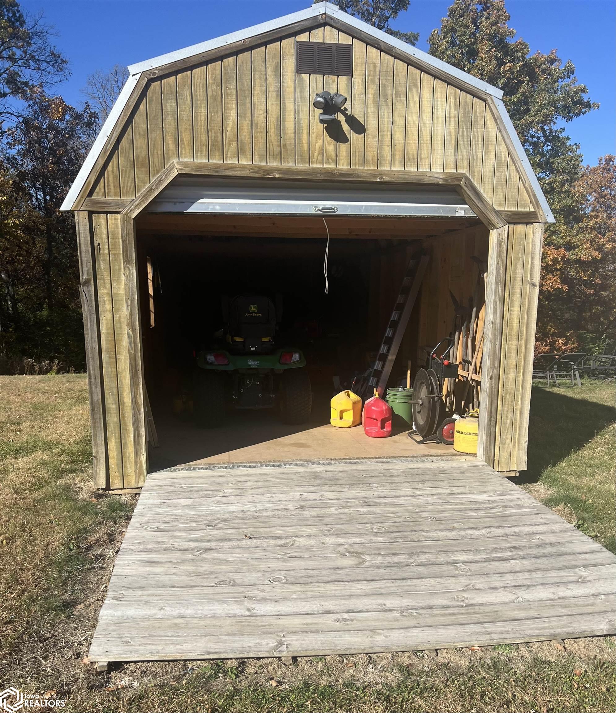 storage shed. Area fenced in behind held a hot tub, which is not included