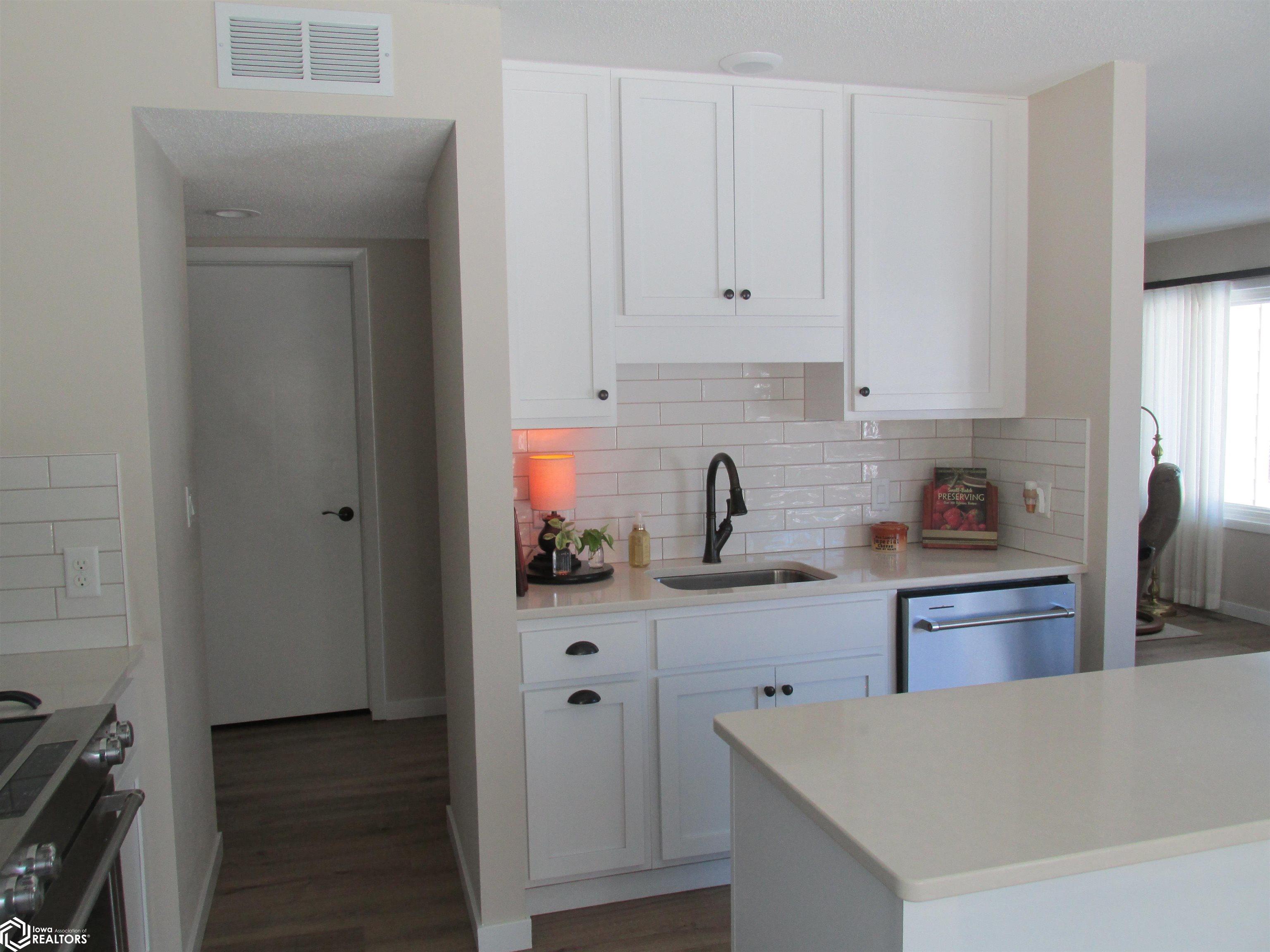 Doorway leads to the hallway to the bedrooms, laundry room, & bathroom.