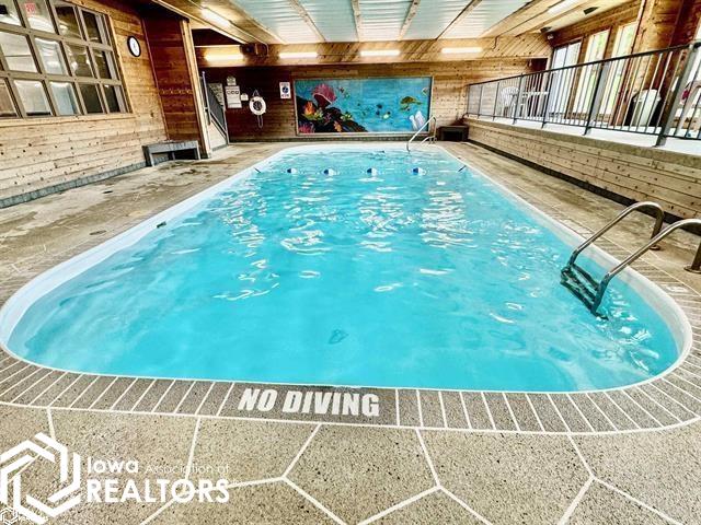 Indoor Pool ~ also a hot tub.  Deck with tables and chair to enjoy family time.  Access to the outside deck overlooking green space and harbor.