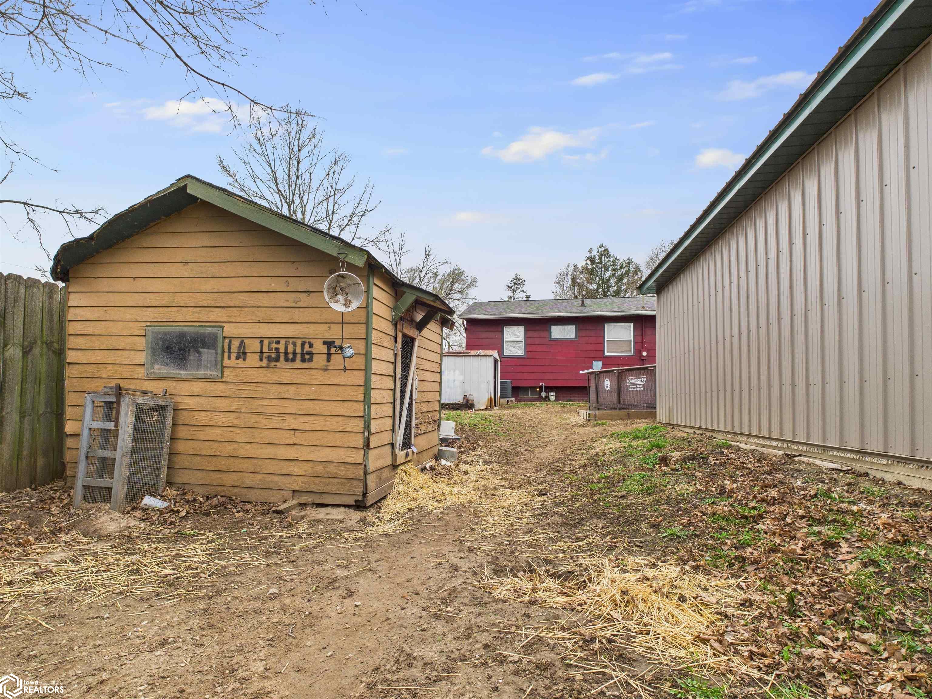 View of yard behind Chicken Coop toward home