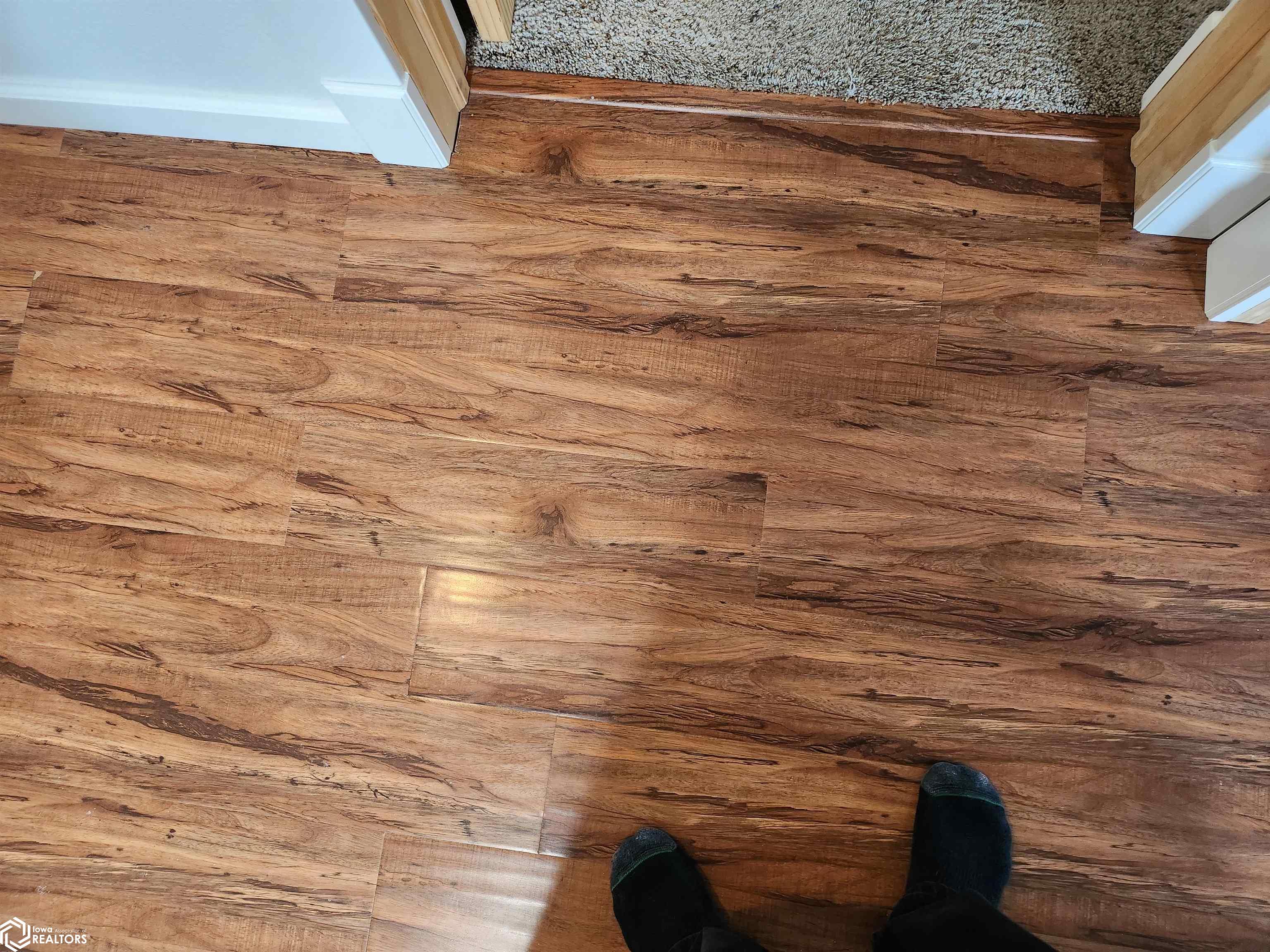 New laminate flooring installed in living room, main hall on main floor, and TV/Lounge area in lower level