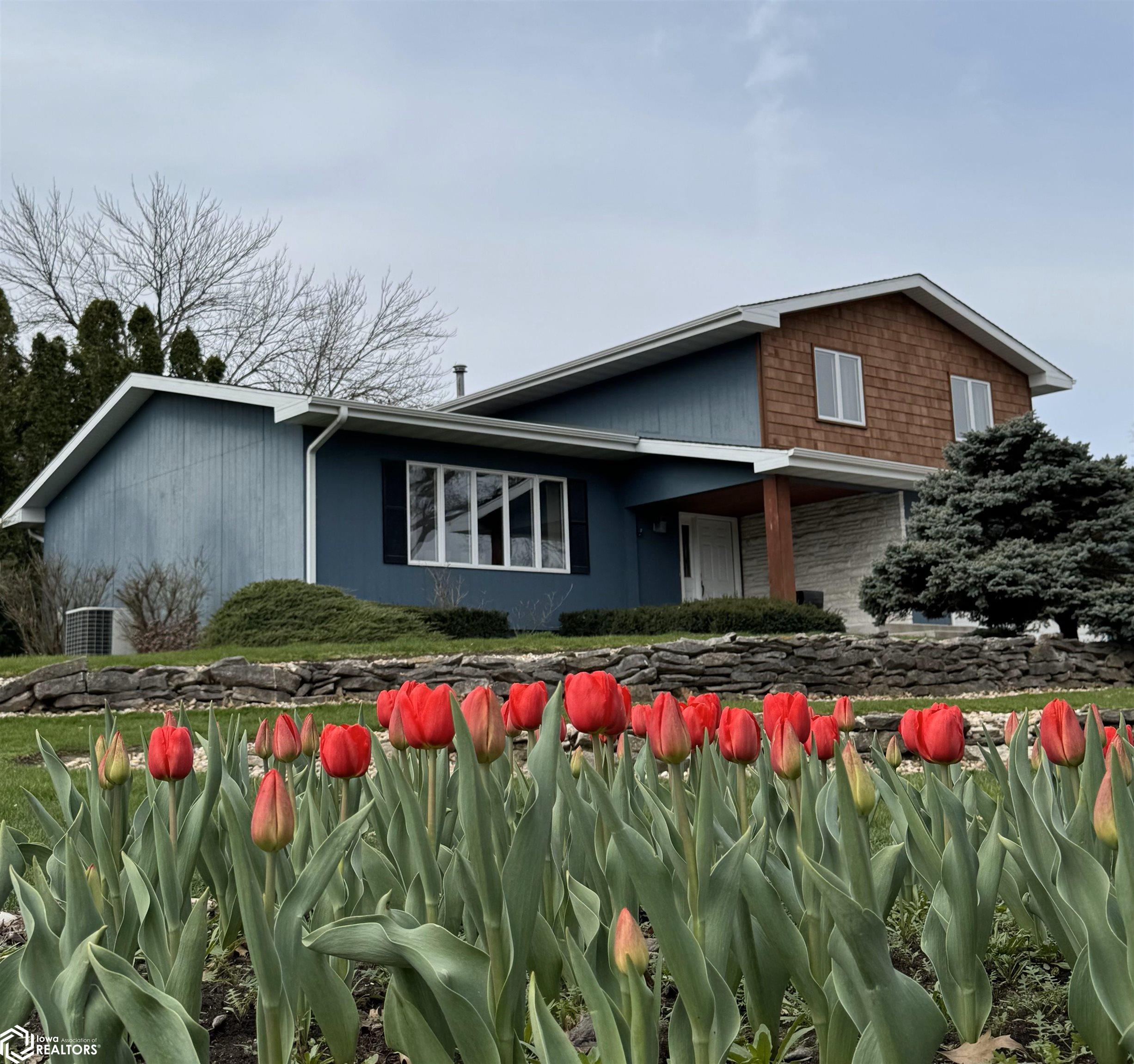 With established tulip bed and terraced yard