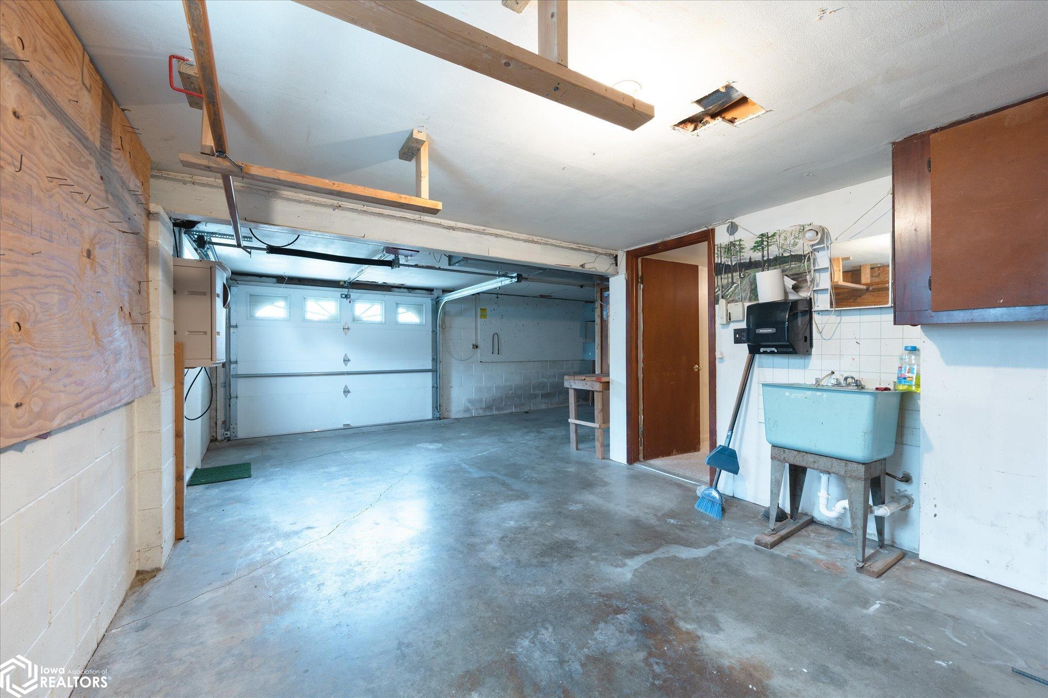 Well thought out garage with sink and entry door to extensive indoor insulated, heated shop.