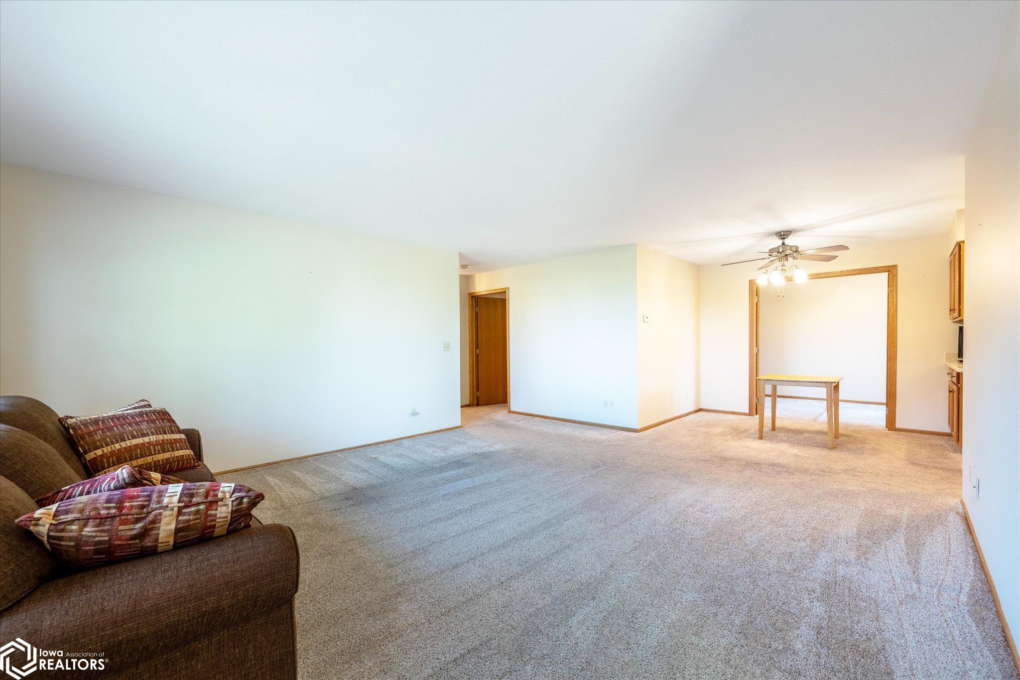 View of the spacious living room looking NW into the eat-in kitchen area.