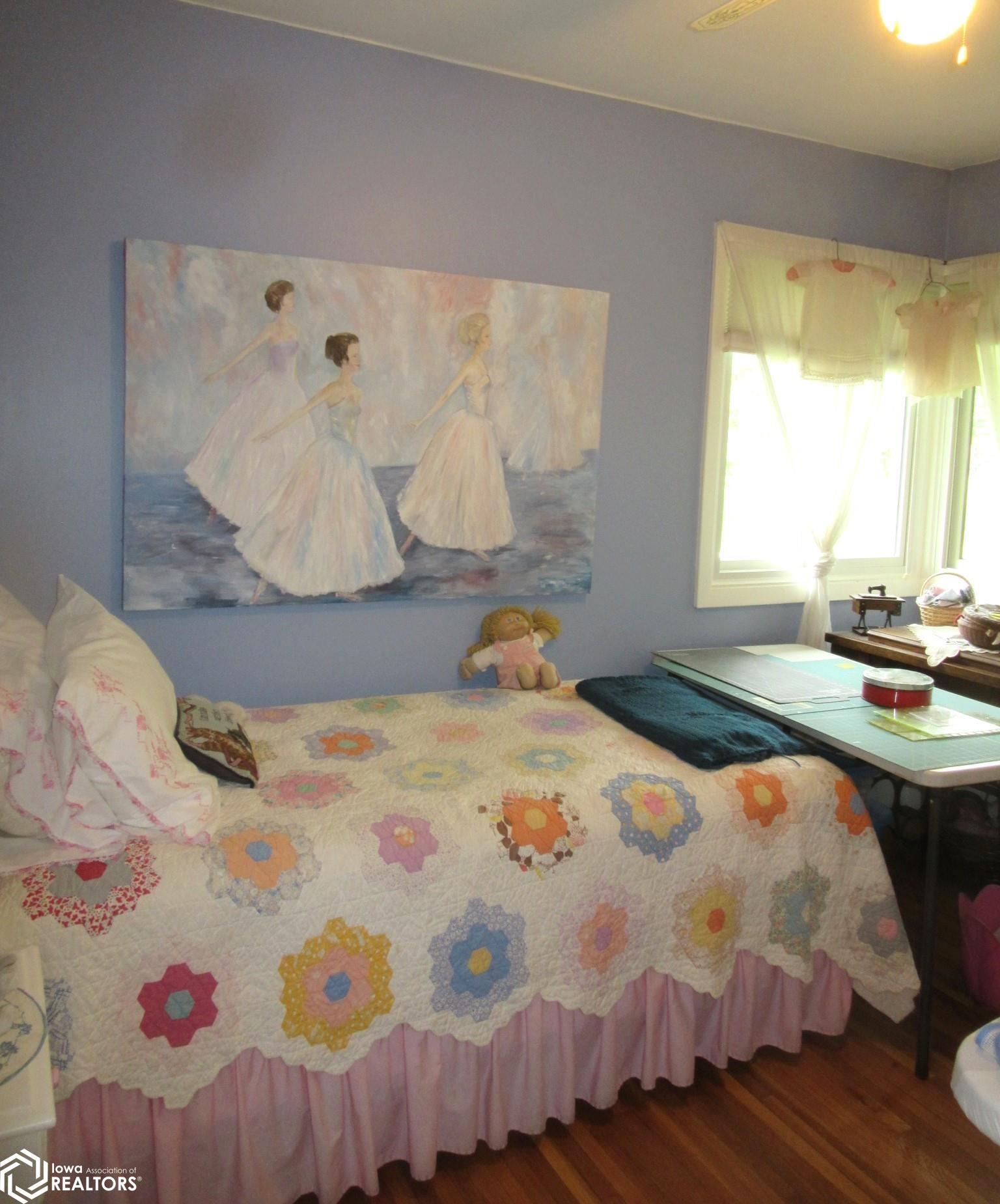 Bedroom/Sewing room...Corner windows, Good closet, and hardwood floors.