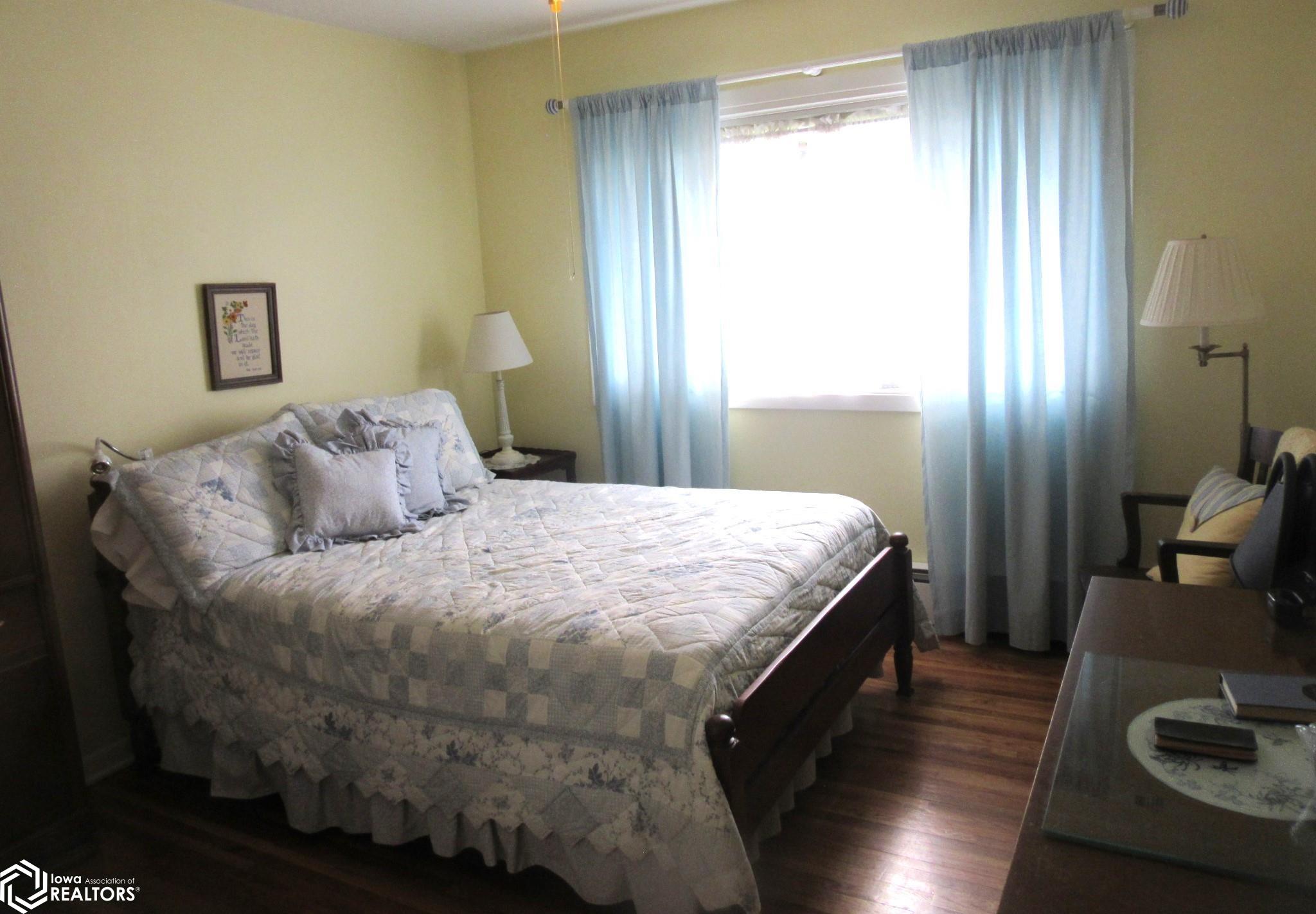 Bedroom with natural light and nice closet with shelving.
