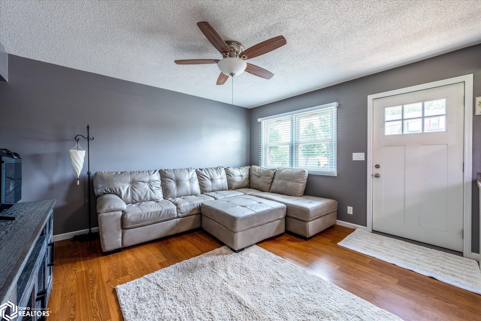 Front door opens welcomes you to a living room and kitchen.