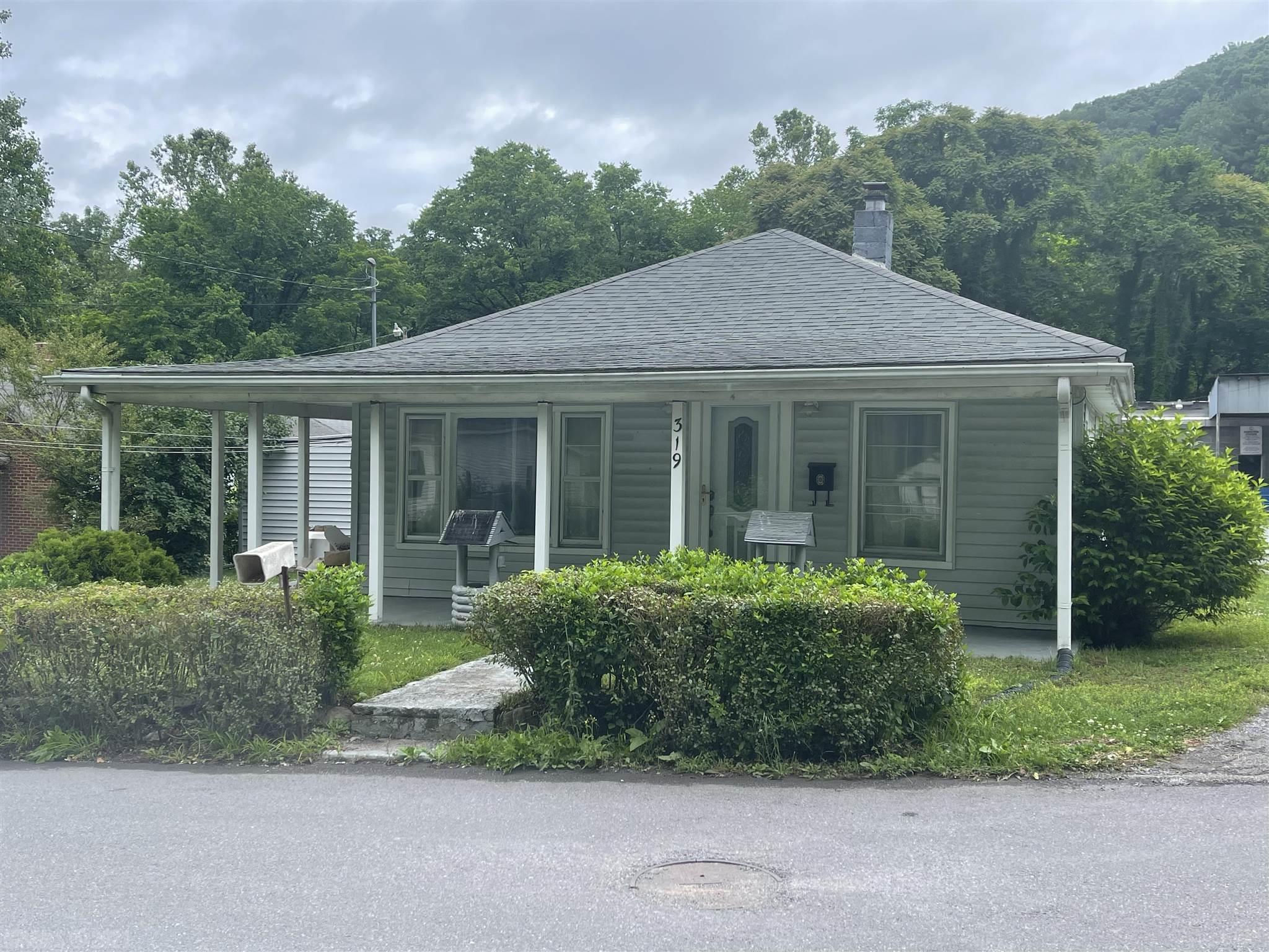 Older home with lots of possibilities, 2br,2ba, carport, beautiful hard wood floors, small screen porch, work shop for your handyman! Call today!