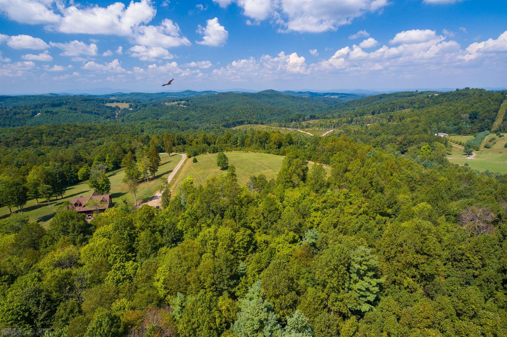This is an incredible 5 acre wooded parcel. You have a great long range view of the mountains, as well as the ability to watch the sunset over the mountains. With the lot being wooded, you get to decide how much privacy you have with that incredible view! Currently there is only one home in this development. There are plenty of potential building sites. This lot is priced well below tax assessment, and is ready for your dream mountain getaway! You are plenty secluded, but only 15 minutes to amenities and downtown Galax. You're just a short drive to the New River Trail, New River, and plenty of hiking trails. Call today for your chance to see it!