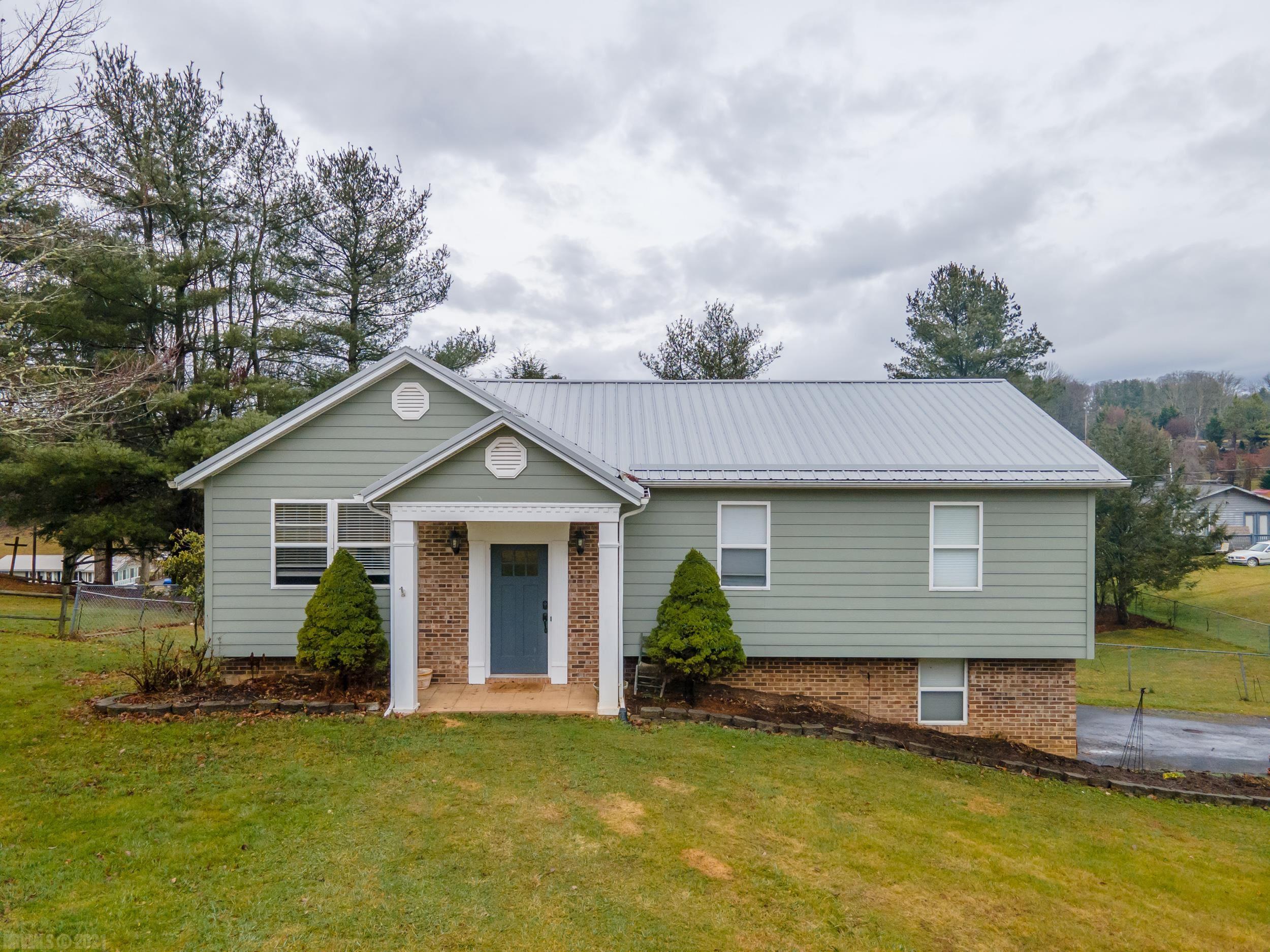 Take a look at this beautifully remodeled home within town limits of Galax. You are in a well established neighborhood, but there are no restrictions either. This home is perfect for the family. You have a 2 car drive-under garage. The back yard is spacious and already fenced in for the dogs and kids to play. This is a nice quiet street. You are convenient to all that Galax has to offer, such as a hospital, Walmart, Lowes, Hobby Lobby, a bowling alley, a movie theater, many different eating establishments, and for the outdoors person, there is plenty of fishing and hiking with the New River and New River Trail. You also have your choice of Fiber Optic High Speed internet. You're on town water and sewer. You are less than 20 minutes to Interstate 77, about 35 minutes to Mount Airy, NC, and only an hour to Winston Salem, NC. This home is completely move-in ready. It has beautiful hardwood floors and tile throughout. It also has HardiPlank siding, and a metal roof. Call today!