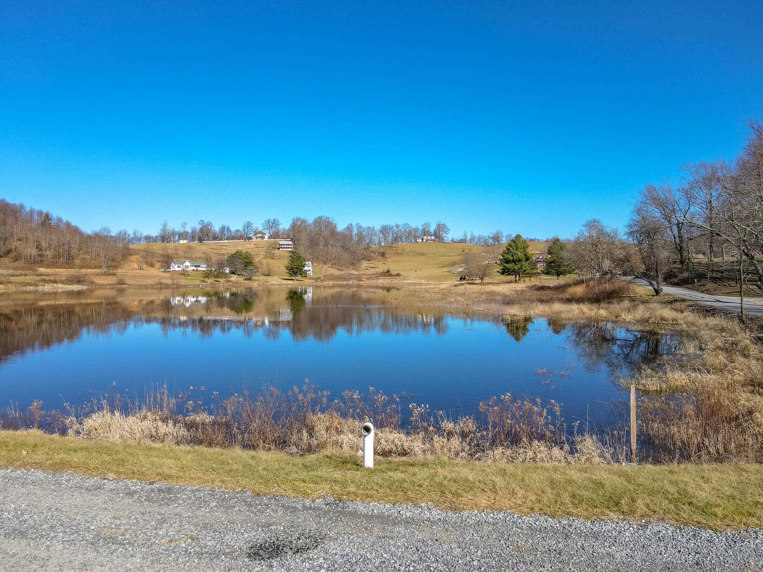 This 2.17 acres are gently sloped, and would not be difficult to put a driveway in and build your dream home. The main attraction here is the deeded access you have to the private lake, which is over 9 acres in size. The lake also has a picnic shelter available for lot owners. The location is just 5 miles to the grocery store in Independence, and conveniently located to hiking trails, trout fishing, and state and national parks. There are equestrian trails around also. You have the perfect location for the avid outdoors person. This lot already has a road bed for a driveway. You are just 30 minutes to Galax, and 40 minutes to Wytheville. Both locations offer a variety of shopping, a hospital, and more. You are also just an hour and a half to Winston Salem, NC. This is a nice opportunity to get in cheap before the area's growth increases the values of property! Road and common area maintenance fees are just $200 per year per lot. Very gentle covenants and restrictions.