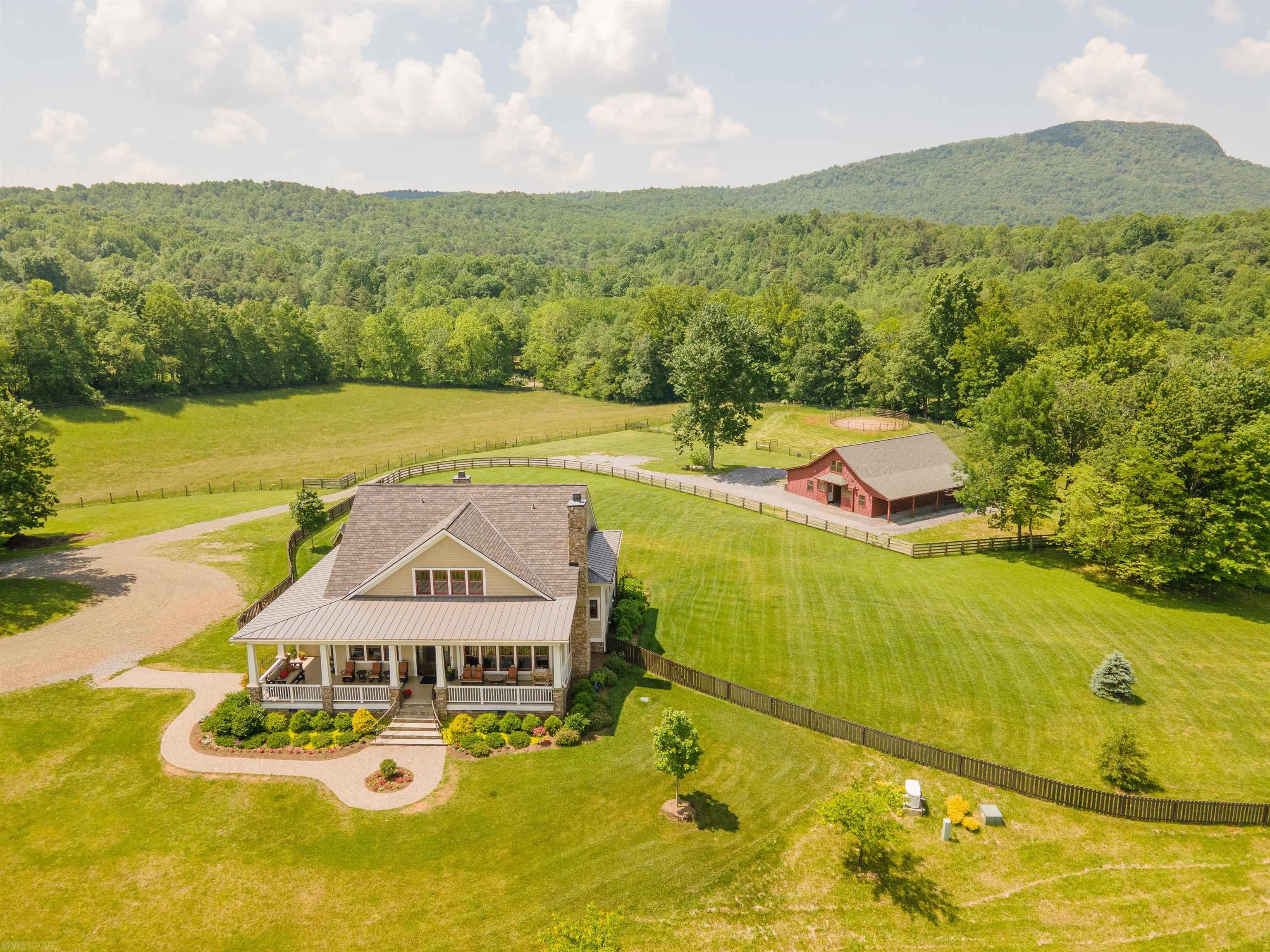 Spectacular horse farm nestled in the Blue Ridge Mountains of southwest Virginia. 105 gorgeous acres with 2 homes, 2 barns, luxury barn apartment and arena. Completely fenced and cross fenced.  The main house, completed in 2017, reveals the fabulous mountain views. Natural light flows in from large windows in every room. Featured in the Floyd County Tour of Homes, this craftsman style home shows impeccable attention to detail at every turn.  The guest house, a charming, fully renovated 1820 farmhouse, overlooks the spring fed pond well stocked with bass.  The barn, built in 2020, is a horse owners dream. 5 stalls with rubber mats, aisle with rubber pavers, tongue and groove pine walls and ceiling, wash rack, air conditioned tack room and apartment. Many more features along with room dimensions under documents tab.