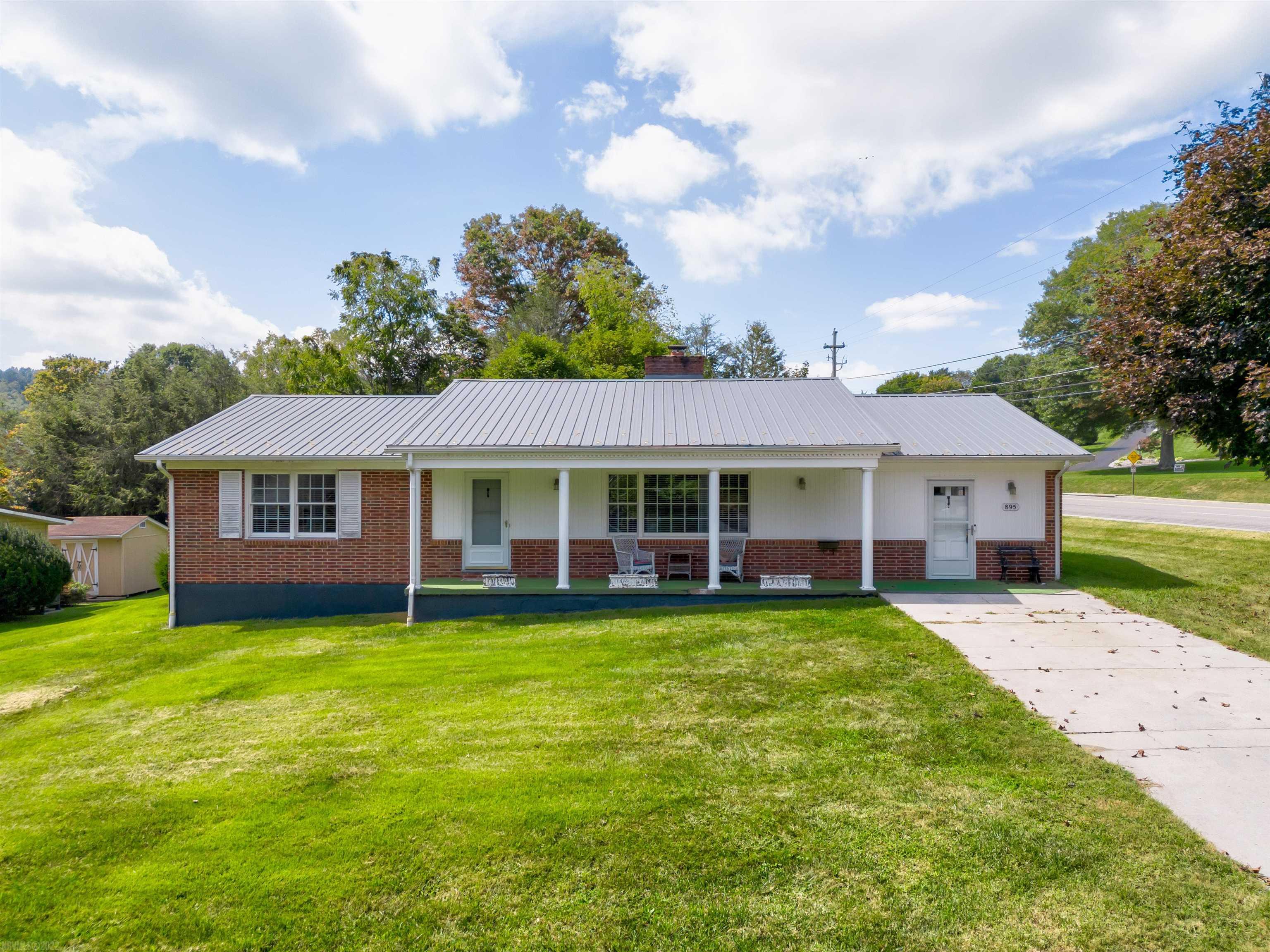 OPEN HOUSE: Saturday October 1st 11:00 am-1:00 pm. Ready for convenience to restaurants, shopping and the interstate while feeling like you are away from everything? This beautiful brick ranch style home fits exactly that with the bonus of one floor living. in addition to a nice sunroom, dining room, kitchen, and living room the first floor provides three bedrooms, two full bathrooms and laundry on the main floor. Maintenance free metal roof, heat pump and water heater recently replaced. Off street parking in front and behind the house. Enjoy sitting on the covered front porch or relaxing in the spacious back yard. Schedule your showing today!