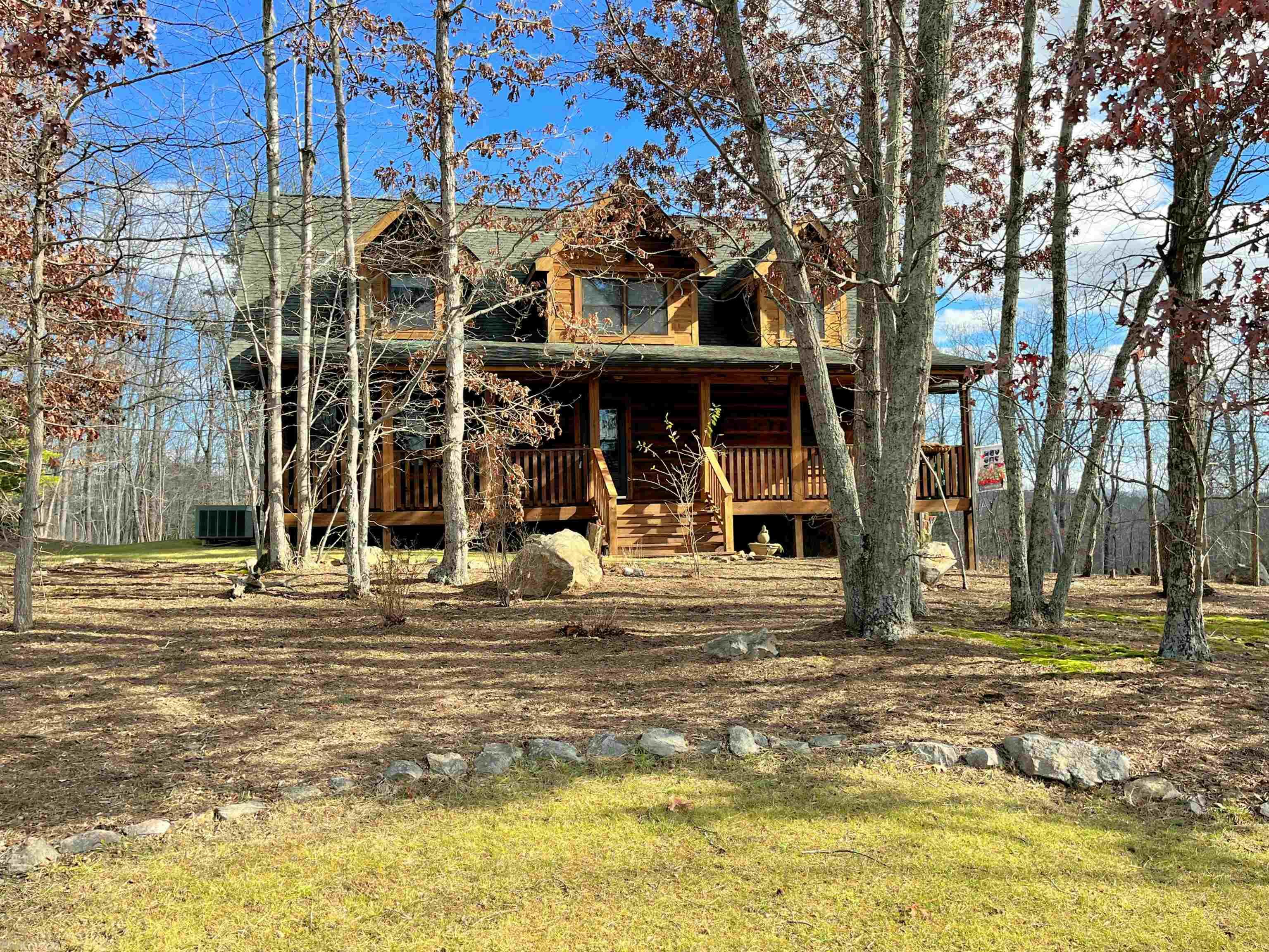 Magnificent 3 bedroom, 2 full & 2 half bath log home on a very private 1 acre lot w/ mountain views, located w/in minutes to NRV Mall, 460 Bypass, Radford University & an easy commute to Blacksburg & Virginia Tech. Enjoy the sunsets from the covered, rocking chair, front porch overlooking a wooded front yard & the rear deck has an open view of the enormous back & side yard. Enjoy your morning coffee in the screened in porch just off the eat-in kitchen w/ built-in corner cabinet & updated appliances (2021). The light pours in thru the wall of windows in the living room w/ enormous vaulted ceilings & a stone fireplace. The Main Level, Primary Bedroom has a separate entrance to the rear deck & the bathroom has a walk-in closet, double vanity & separate shower & tub. Office on main level could be used as a 4th bedroom & 2 spacious bedrooms upstairs. The full, finished basement has a wet bar & half bath perfect for game room or den. This home is freshly painted & move-in ready!