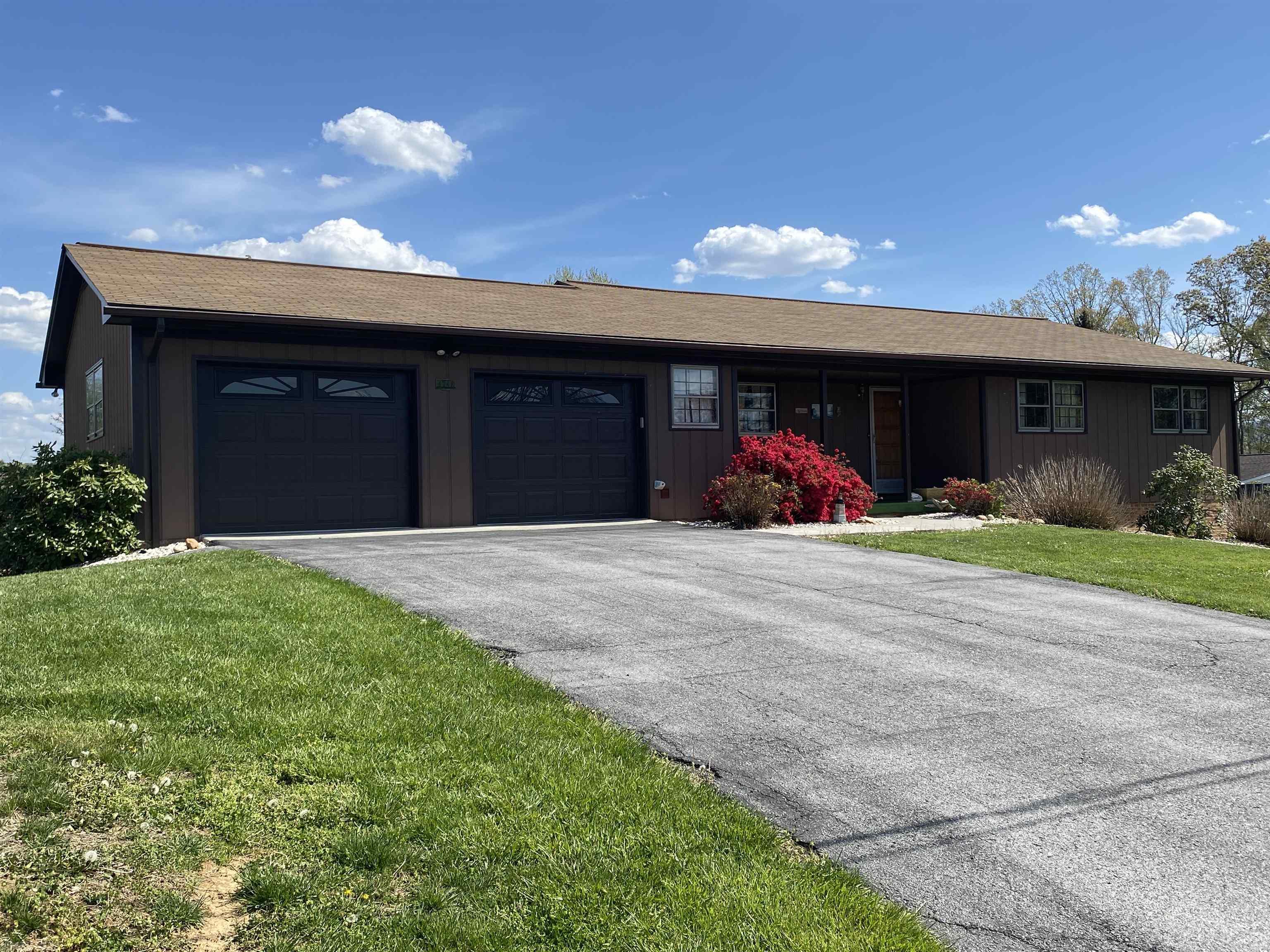 Enjoy lake living, just a couple miles off the interstate.  This spacious ranch home offers 3 bedrooms, 1.5 baths, living/dining area with large window, family room (open to the kitchen) with a brick wood burning fireplace. Access to the back deck, with seasonal lake views, from the family room & the primary bedroom. That's just the main level.  Venture down to the finished basement featuring it's own kitchen with a cooktop, plenty of cabinets & a eat at counter top. Another wood burning fireplace, bedroom, office w/closet, large cedar lined walk in closet, & bath with step in shower. There are 2 walkout accesses to the fenced in area.  In-law suite, teen retreat, lots of possibilities? An attached double garage with a walk in closet. Picnic table & some other items can convey.  Two community boat docks & a boat launch so bring the water toys & enjoy summer fun on the lake!