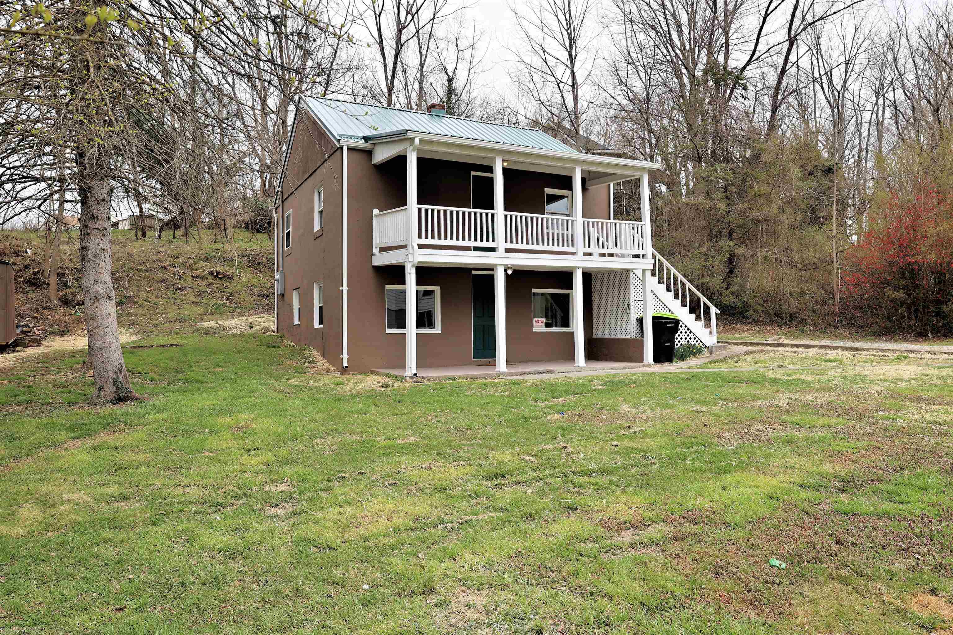 Freshly painted 3BR, 2BA home with brand new metal roof and gutters (2023) located minutes to I-81 and downtown Pulaski. Kitchen, full bath and laundry room are on the main level.  The bedrooms and large living room are on the upper level with a covered two story deck. Enjoy your morning coffee on the covered patio below or covered porch off the living room above. A perfect starter home or investment property.