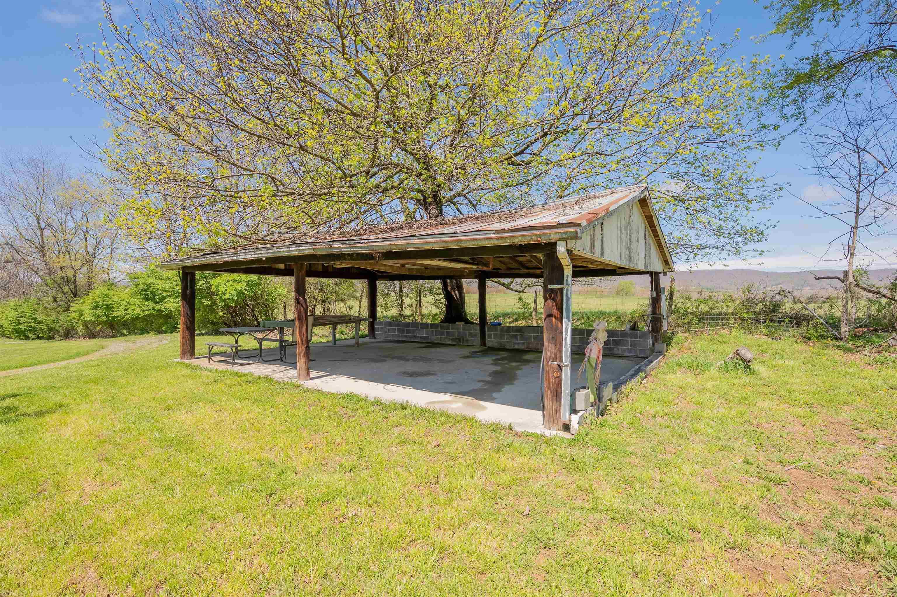 This flat 1.189 acre lot is perfect for building your dream home! This property features a large concrete shelter with 2 additional sheds and multiple peach trees! Property has adjoining farmland with beautiful mountain view.  Property has public hookup to water and electrical hookup.  Call to schedule your showing today!