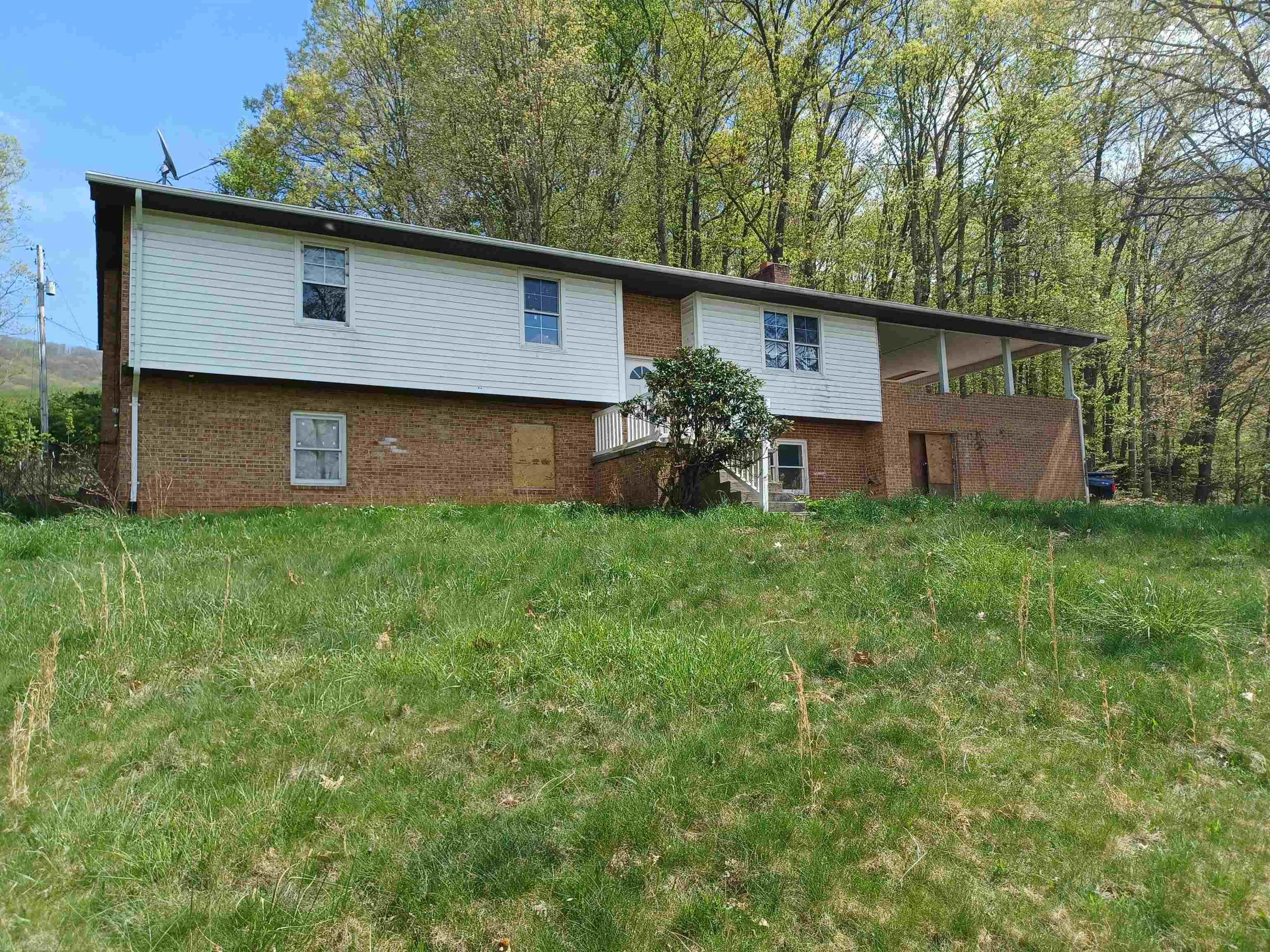 Enjoy this brick ranch style home located on almost 3 acres. This home has mountain views and lots of privacy. This home has 4 bedrooms, 2 full bathes, large kitchen, family room and hardwood floors.