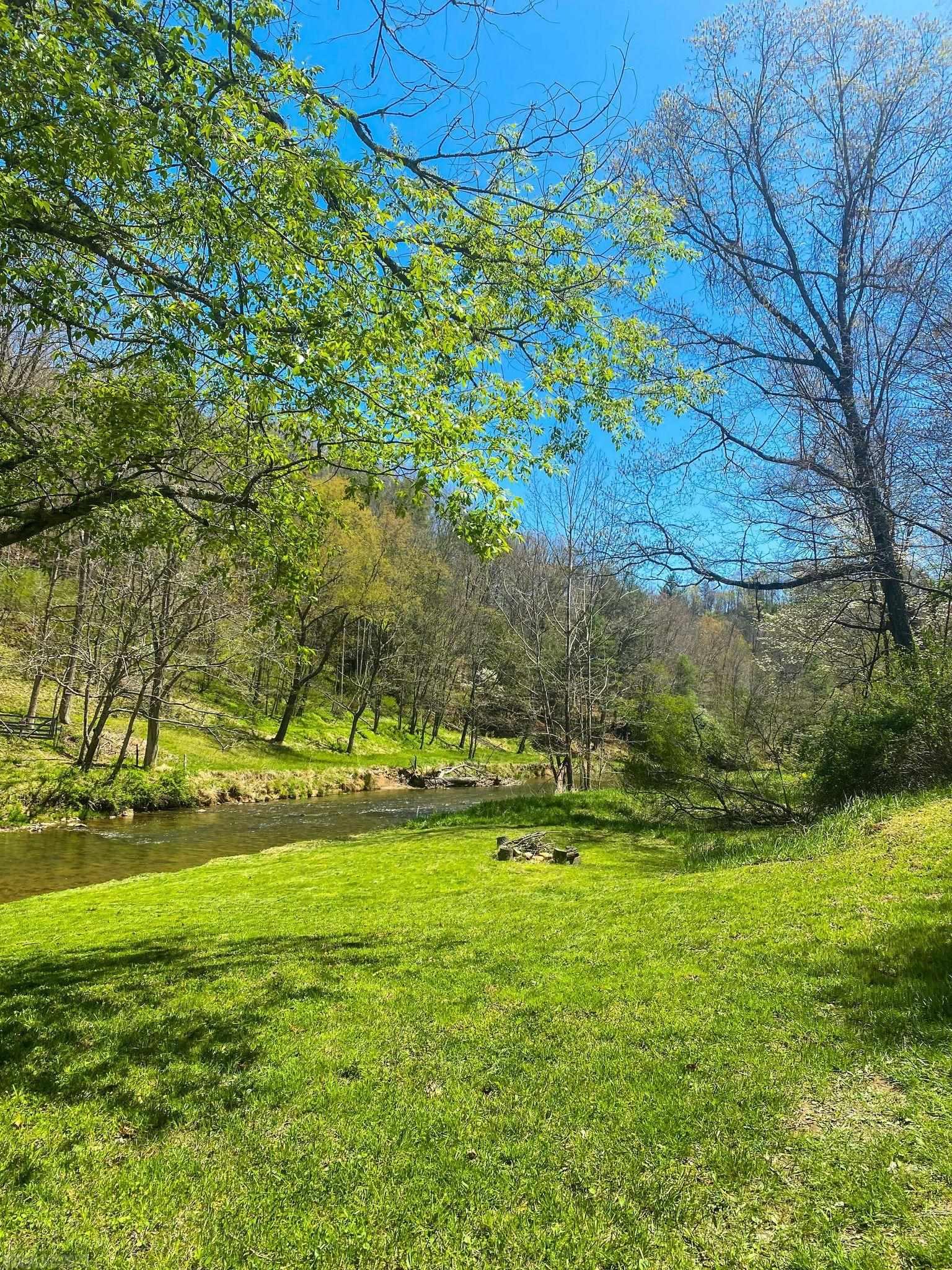 WATERFRONT retreat in the Blue Ridge Mountains. 5+ acre, private oasis in a gated community with 500+ feet of frontage on trout stocked Crooked Creek. Property is broken into 2 semi-equal sized lots. A ~2.3 acre parcel with 1 acre cleared homesite, completed soil study and road frontage, surrounded by woods on a dead end street. And a 2.7 acre parcel with ~1.5 cleared acres on the waterfront and a circle driveway with a brand new, 150 sqft, wooden building that includes a window and 2 lofts. The waterfront includes a fire pit, a large level area for gathering, a lovely walk through the woods on an old, very wide, dirt road, a vine twisted, semi clear area that was a beach (just needs more sand), a tree swing, and multiple places to walk into the creek with ease. Perfect for fishing, wading, tubing, cookouts, camping, bonfire nights, etc. There are also 2 community common areas that allow for fishing deeper waters, tubing longer runs, and the whole community is equine friendly! No HOA.