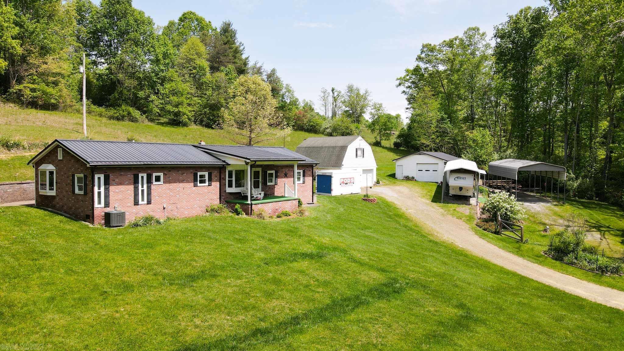 Escape to your very own private oasis on this 2.3-acre property nestled in the serene countryside surrounded by nature and tranquility. The property includes not one, but two large garages and two carports, providing ample space for all your vehicles, boats, and recreational vehicles. Bonus storage space above the garage. The covered deck and paver patio offer the ideal setting for outdoor entertaining and dining. This spacious home features 3 bedrooms and 2 and a half bathrooms, including an ensuite. In the family room a cozy gas fireplace is perfect for chilly nights. Updates include, newer heat pump, metal roof, windows, some flooring and kitchen.