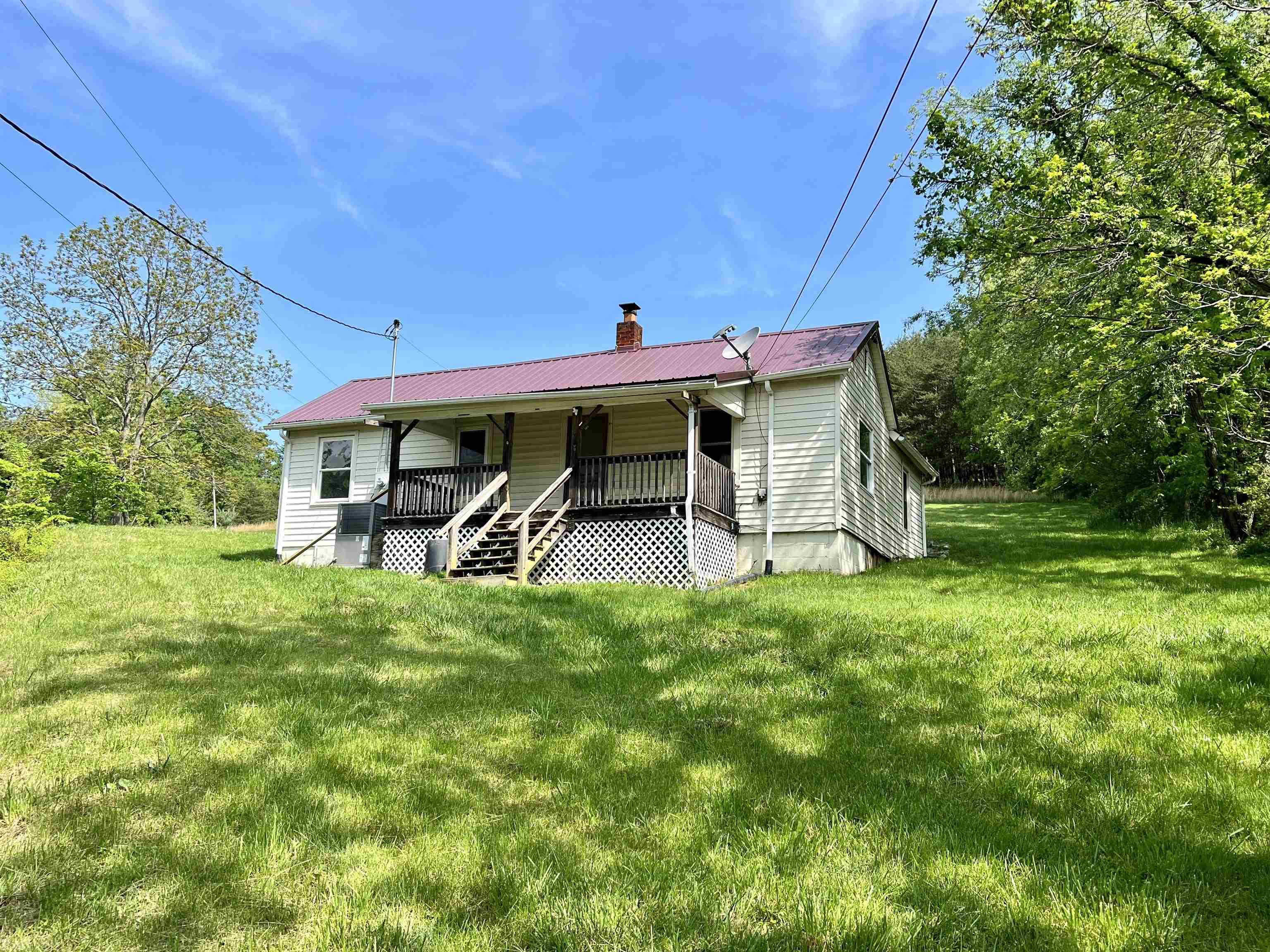 Nestled in Bland County, VA, this 2 bedroom, 1 bath home is a hidden gem awaiting some tender loving care. With approximately 1000 square feet of finished space, it presents a canvas for customization and personalization. The potential is immense. Features include a metal roof, heat pump, all tile and laminate wood flooring except for the bathroom, and tilt windows. Situated on nearly an acre of land, there's ample room for expansion and outdoor activities. Enjoy the view from the covered front porch. Outbuilding for storage, paved road frontage, septic, and shared well. Perfectly located near the Appalachian Trail, it offers endless opportunities for outdoor adventures. Embrace the chance to transform this dwelling into your dream home, surrounded by the natural beauty of Bland County.