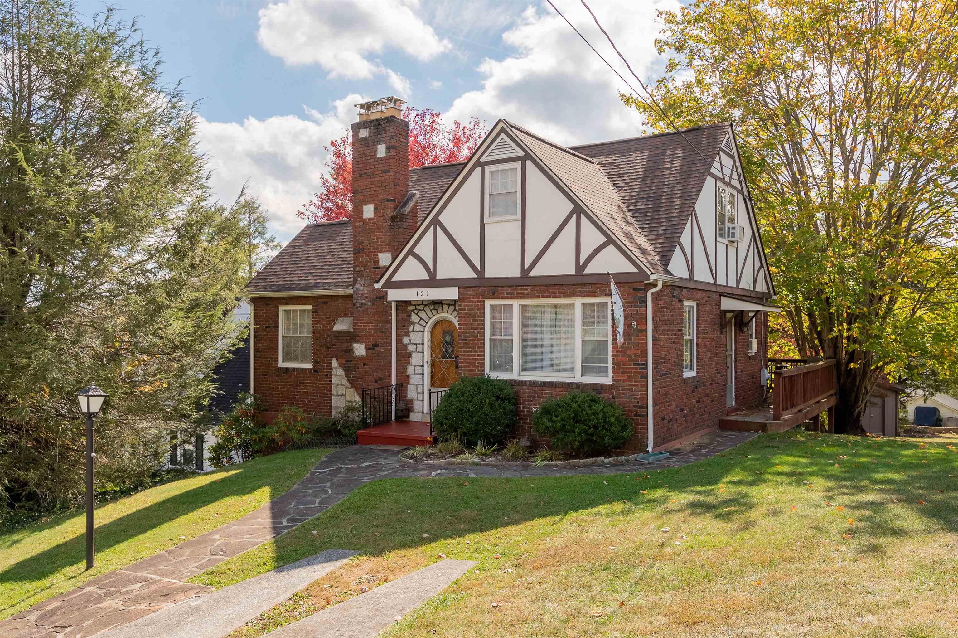 You will absolutely love this charming Tudor home in the historic area of Pulaski County! Sure to steal your heart from the start with a mix of brick & wood exterior, flag stone walkways, new roof & gutters 2018 and an array of mature trees & landscaping. Step through a gorgeous wood door with stained glass to find gleaming hardwood flrs, arched entries and beautiful built-ins all in sun-filled floor plan ready to accommodate daily needs & entertaining style! Sprawling living room with large windows, built-in bookcase and gas fireplace. French door to sunroom with exposed brick & panoramic backyard views. Classic chandelier hangs in the dining room ready to light the way for your finest dinner parties. Kitchen is just next door for easy serving options w/ample cabinetry & counter space. 3 beds & 2 full baths cover your growing needs. Walkout basement offers excellent storage or create more living space. Rear deck for BBQs overlooks lush backyard with peeping mountain views. Call today!