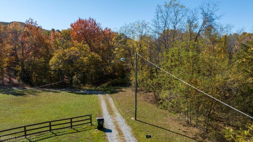 Drive just 9 minutes from downtown Pulaski (recently named Virginia’s most affordable place to live) and you’ll enter a beautiful little mountain valley at the end of Highland Terrace road that offers a pure country feel, packaged with the convenience of city utilities – the best of both worlds!  -Country Mountain Life but w/City Amenities  -All Utilities (Power, Water, Sewer)  -Legal Public Road Frontage  -Only 9 minutes from downtown Pulaski  -Buildable, No Floodplain  -Assured Privacy at End of Road  -Abundant Wildlife  -Priced Well Below Market   PROPERTY: This wooded, mountainous, 20 acre parcel offers something special for such a “country” property with end-of-the-road privacy — city utilities! The property is undeveloped but flattens out near the Highland Terrace street easement that curls around the parcel’s NE corner, so it’s very buildable and ready for your new home, cabin, or mobile home.