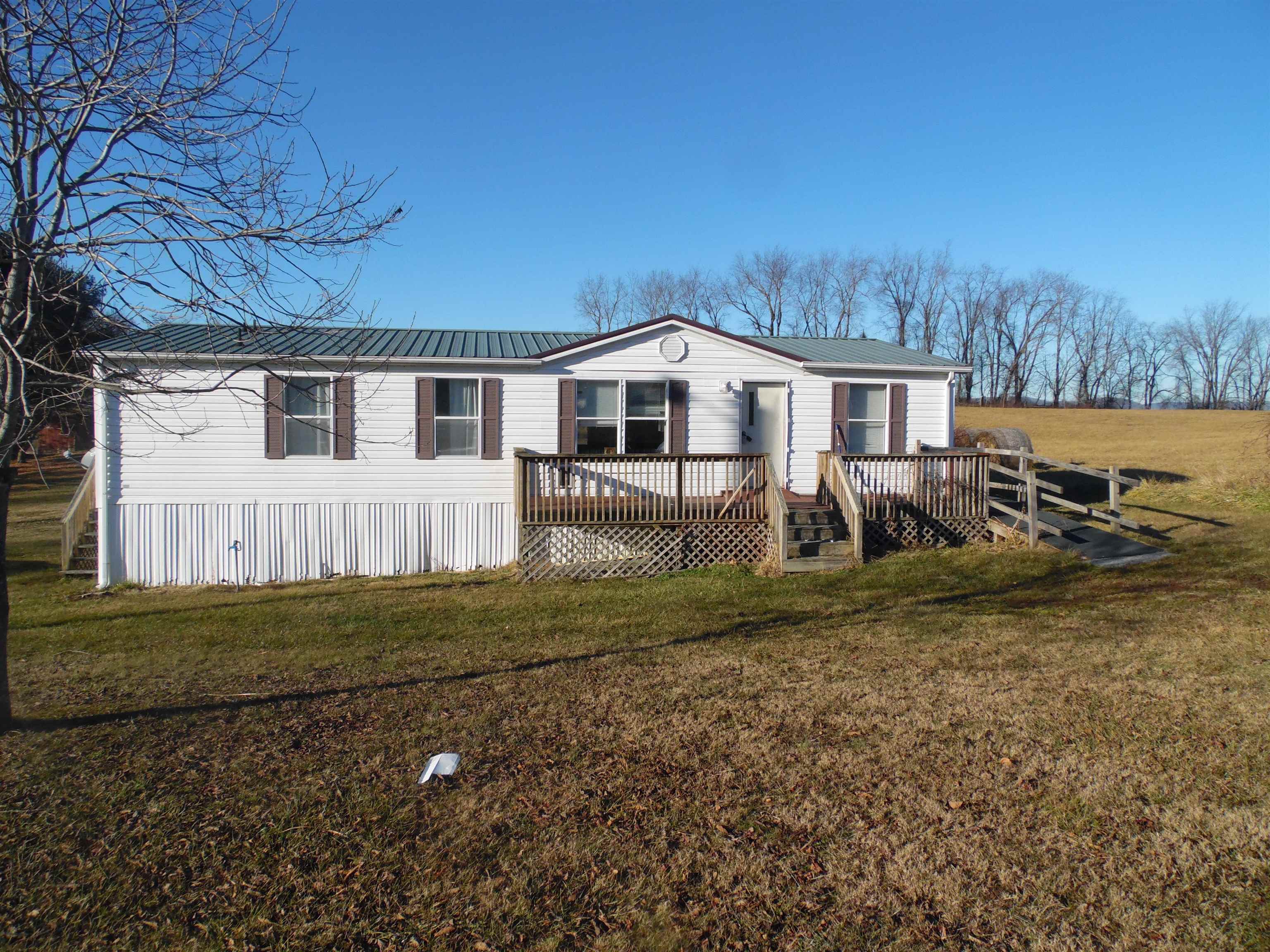 This three bedroom two bath home has an open floor plan with a living room dinning room and kitchen. If you want a great country location this is it. There are two storage plus single wide trailer that convey with the property. The home is ADA accessible.