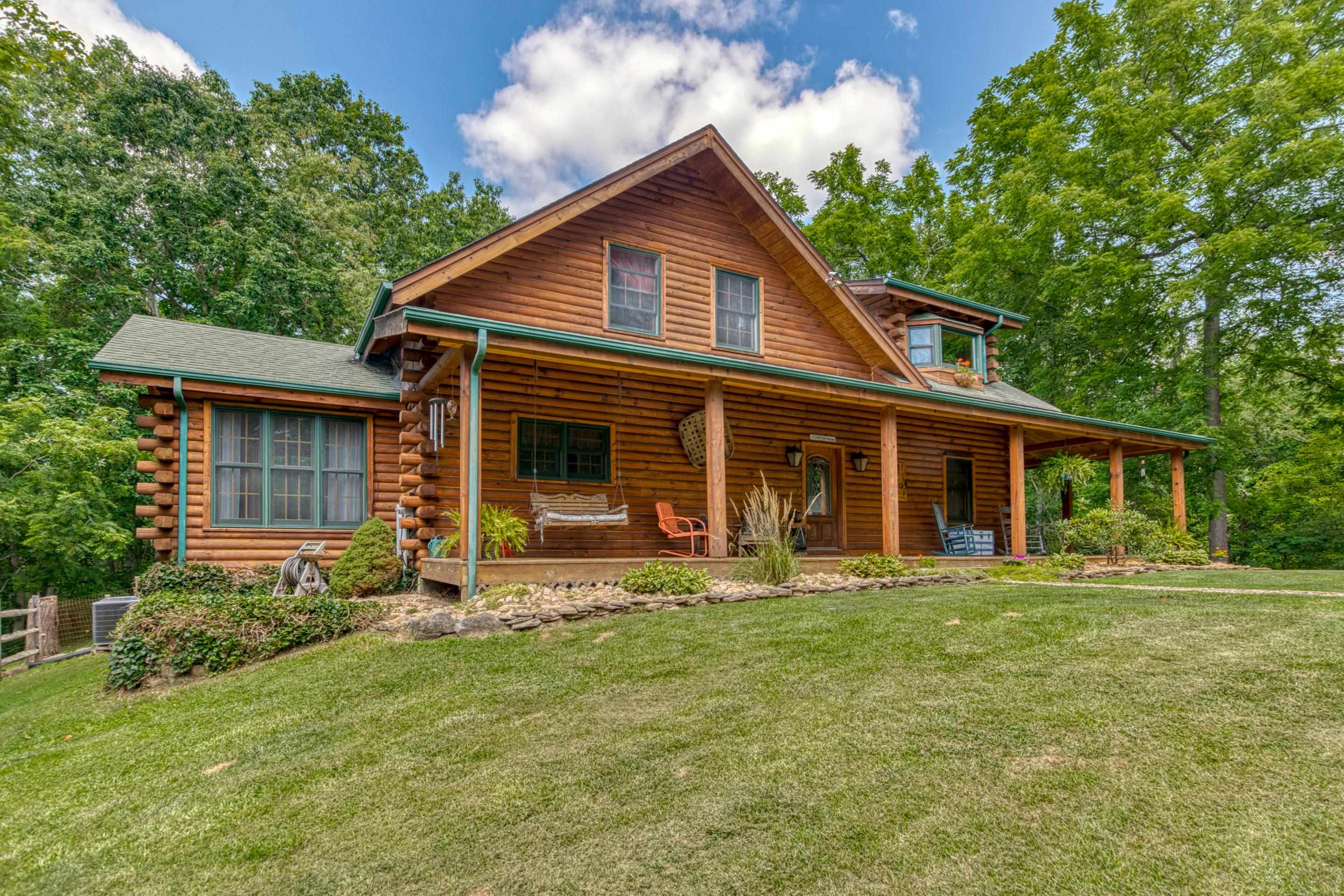 Nestled on 14.5  acres this cozy log home offers seclusion and convenience. Only 6 mins to downtown Christiansburg and Interstate I-81.  When you walk in the front door you will immediately have the sense of warm and cozy. The high vaulted ceiling in the great room is accented beautifully with exposed wood beams, 6 large gable end windows, and stone gas fireplace.  3 bedroom , 2 bath , sunroom, laundry/mudroom w/ utility sink, Kitchen offers an eat in bar, granite counters, stainless appliances. Primary bedroom offers a walk in closet, and bay windows. Beautiful hardwood floors throughout the home. Enjoy relaxing on the large wrap around deck and take in the the evening sunsets and wildlife. Double detached garage for  and plenty of parking space.