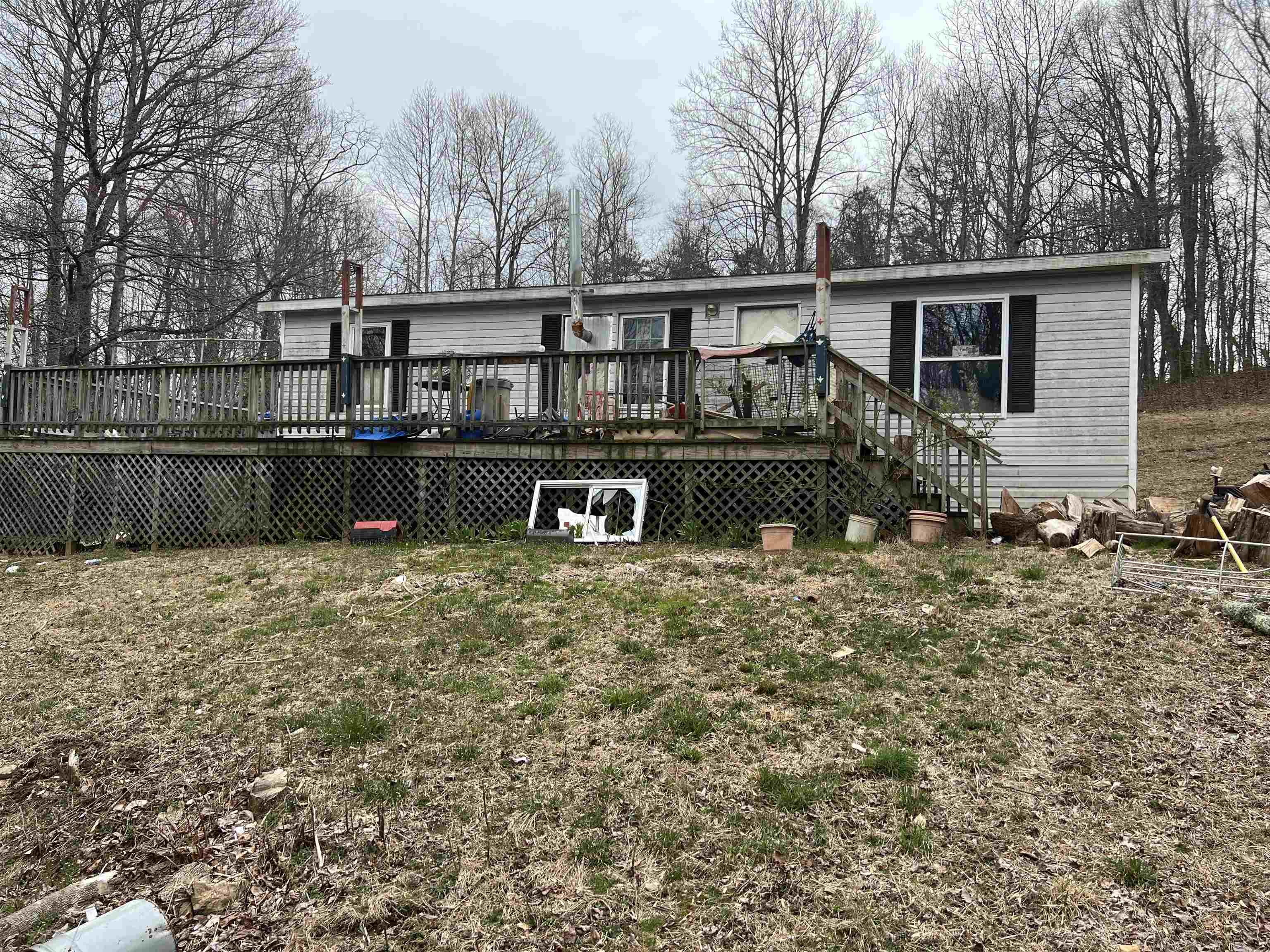 If you are looking for a home that sits back in the woods then look no farther. This 3 Bedroom 2 Bath Fixer upper Double Wide sits on 4.3 Acres. The property needs a Good Cleaning and alot of trash removal but has loads of potential. You will probably need a 4 wheel drive or a vehicle that sits up off the ground to get to the property. My Honda Civic didn't like the Driveway. The property is being Sold AS/IS no repairs or cleaning up will be done.