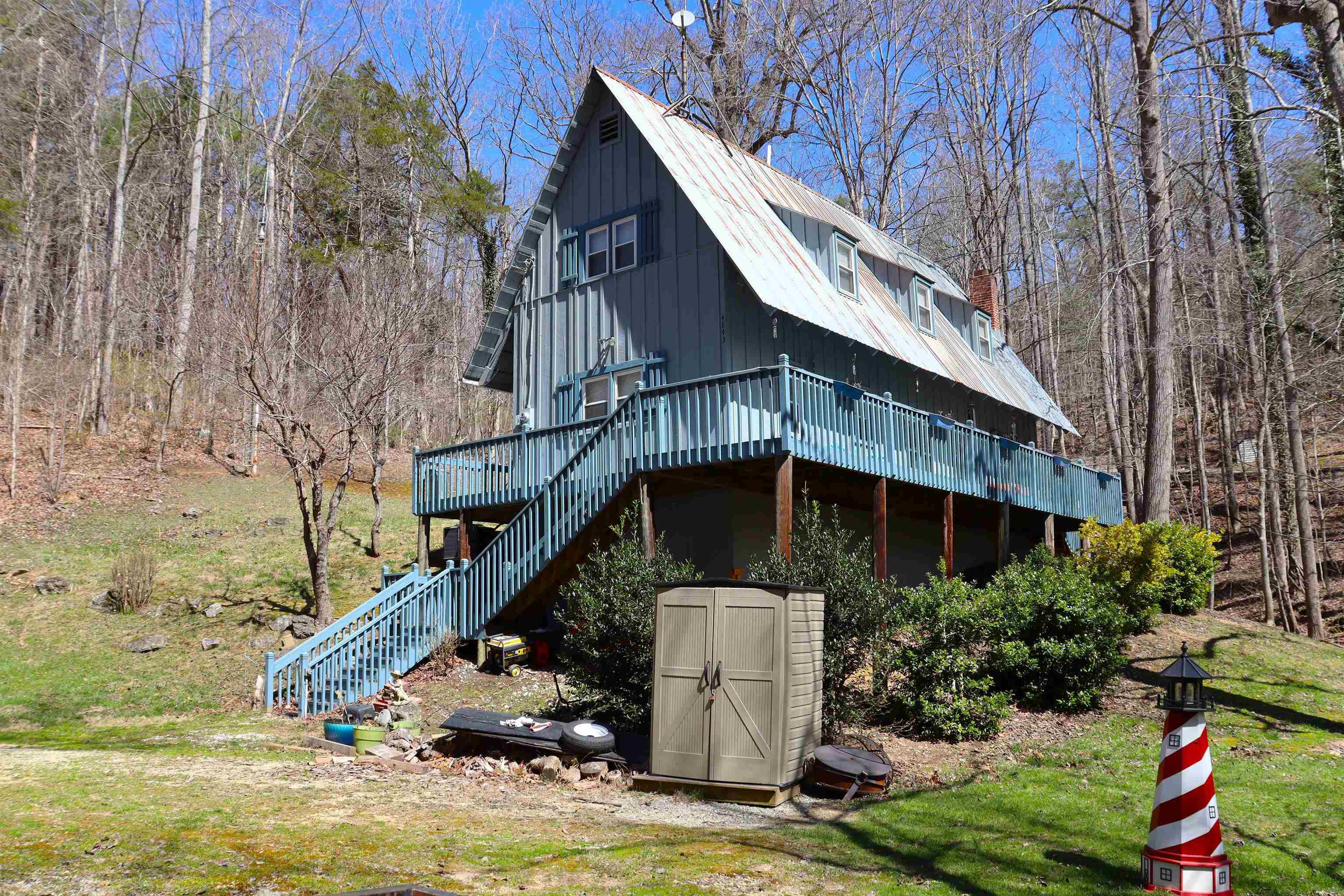 Rustic Waterfront home located only about 1 mile from I-81 interstate. Beautiful waterfront in the end of a cove. 3 bedrooms, 2 baths, living room with a fireplace, kitchen with eat at bar, wood cabinets, stove, refrigerator, and microwave. Large bedroom on the main level. Bath on the main level with a claw foot tub. Upper level offers 2 bedrooms, bath, office area, and a small setting area. Great views of the waterfront from the wrap around decks, Very large 16 x 16 rear wooden deck for cookouts. Part basement for storage with a dirt floor.