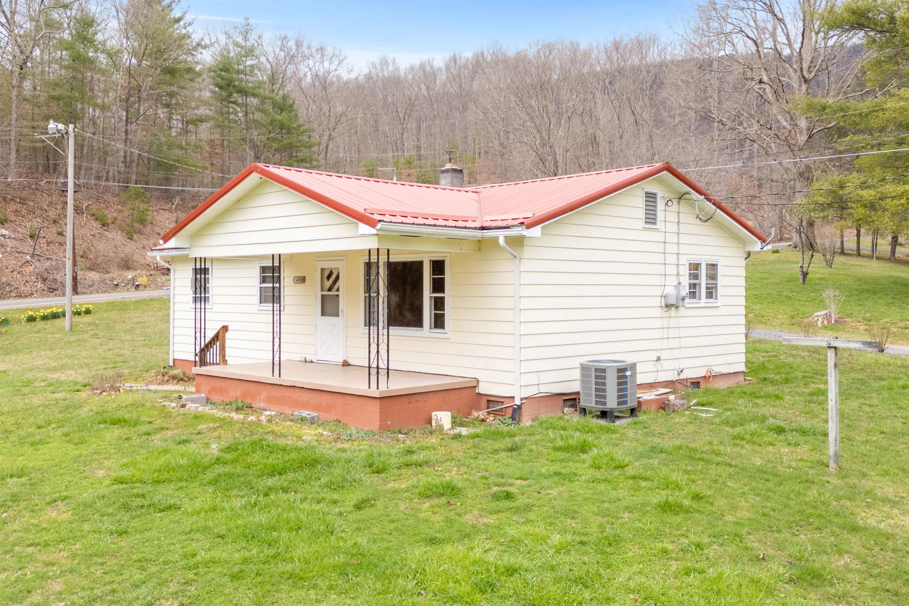 3 BR 1 BA ranch home on just under a half acre in Rocky Gap, VA. Located less than a half mile from I-77 near East River Mountain Tunnel and the WV/VA state line. Recently surveyed and recorded. Public water and a private septic system. Heat pump that is only about 6.5 years old, an approx. 3 year old metal roof, large covered front porch with a beautiful mountain view, oven, refrigerator and small outbuilding included, and hardwood flooring through most of the home. Existing flue in the kitchen/dining area. Great starter home or investment opportunity. Located on US RT 52, which is state maintained. High school and post office are within about a mile or so. Great location and popular price range for a lot of potential buyers!