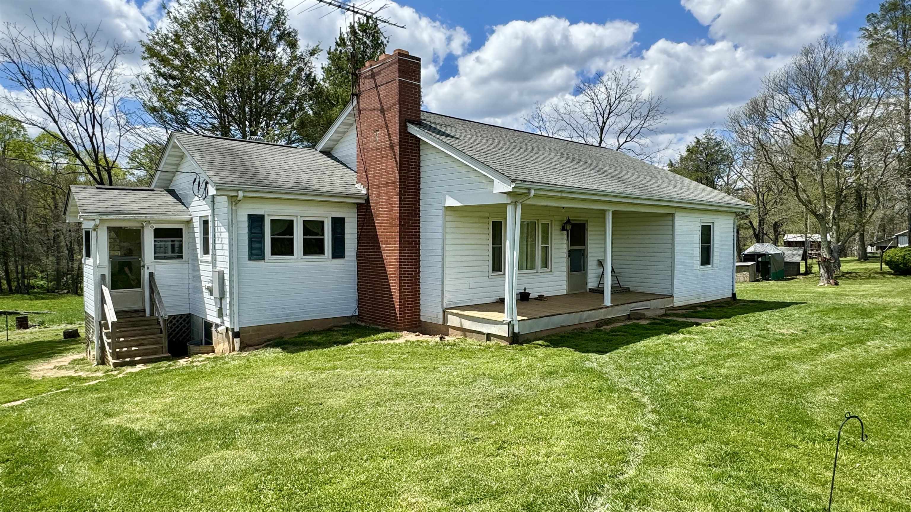 Great potential just off the Blue Ridge Parkway (~0.1 miles away)! This 3BR, 1 BA home offers wood floors, a full walkout basement, upstairs storage, an RV hookup, numerous outbuildings and ~2.75 acres. Updated electric panel box, laundry in basement, covered front porch, and a nice mix of open yard and woods are also included. Take a look at the photos and schedule your appointment today!