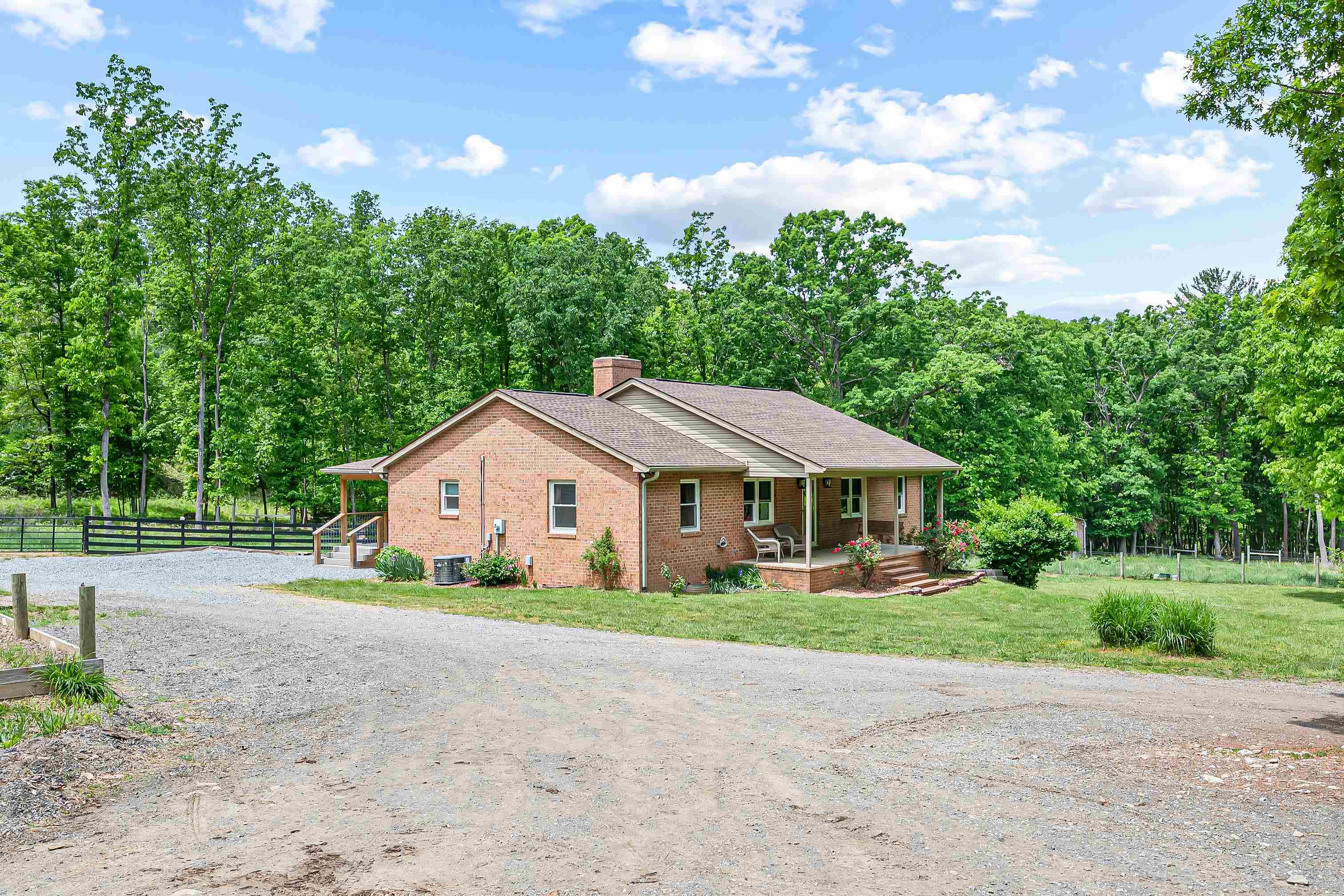 This 4 bed 2 1/2 bath brick ranch sits on a level and secluded 6.4 acre lot that is conveniently located directly between the amenities offered by the New River and Roanoke valleys. This property would make a great setting for a mini farm as it features fenced pasture acreage, multiple out buildings+sheds, a large pole barn great for storage and multiple places for equipment! There would be plenty of room for chickens, goats, sheep, and even horses. The front porch and covered back deck make for welcoming entry's to the home and are perfect for relaxing, spending time outdoors, or hosting guests in this tranquil setting. Once indoors the cozy fire place w/ gas logs, custom master bath, finished walk out basement, large bed rooms, and functional floor plan make for a great home!