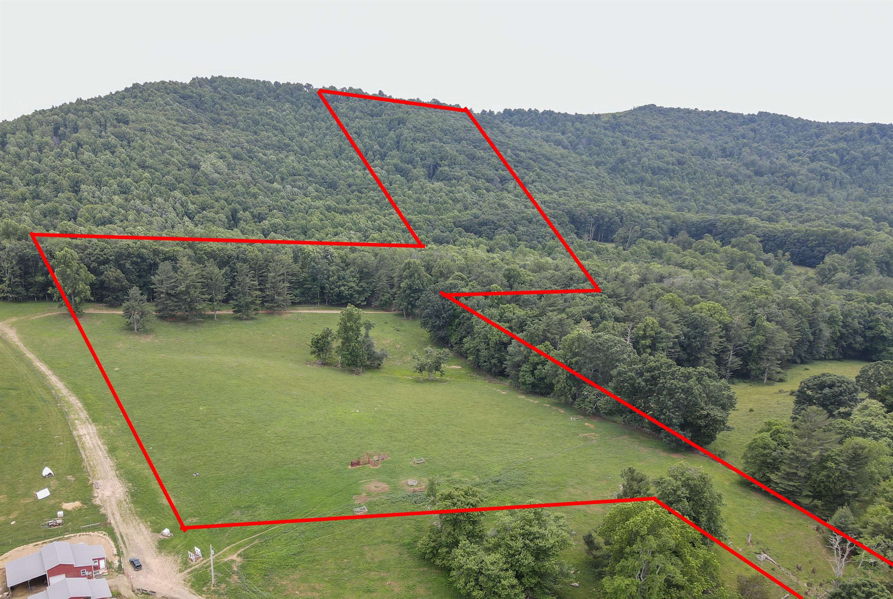 Discover approximately 54 acres of farmland in Floyd County, Virginia, offering stunning long-range views. This property features approximately 9 acres of fenced pasture, with the rest being beautifully wooded. It includes a spring, a creek, and approximately 185 feet of road frontage. Additionally, fiber optic internet is available, ensuring modern connectivity. This land is perfect for farming, recreation, or building your dream home. Don't miss out on this unique opportunity to own a piece of Virginia's countryside. Contact us today for more information or to schedule a viewing.  Boundary lines on photos are approximate. Preliminary survey available under documents icon.