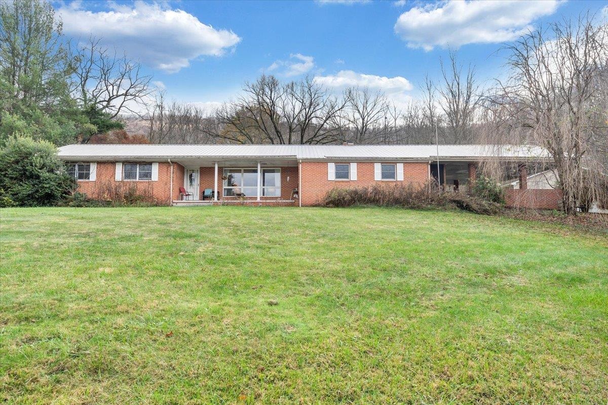 Sprawling brick ranch located just 15 minutes from Blacksburg and Pearisburg! This home totals just over 2,500 finished sq ft on the main level providing plenty of space. Featuring 3 spacious bedrooms, two full bathrooms, and a half bath. Two cozy living rooms, one with a beautiful rock fireplace. Eat in kitchen with a double stainless steel oven. A full unfinished basement  great for storage or future expansion. This home is equipped with a Generac generator and is situated on a 1 acre lot with a flat back yard great for family cookouts. Large detached garage with tall ceilings fantastic for a workshop or car enthusiast. Schedule your appointment today!