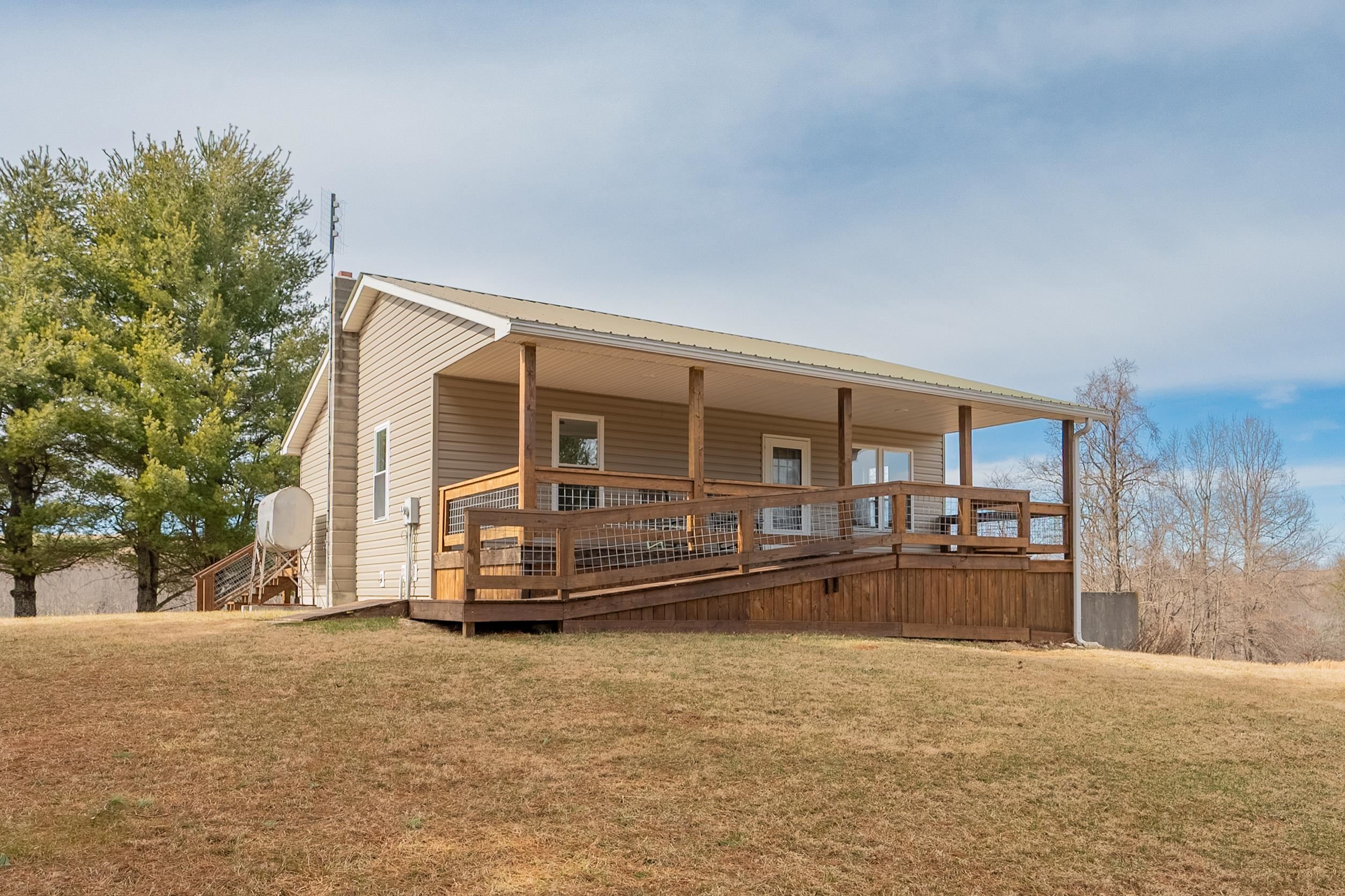 Nestled in the heart of Floyd County, this charming home offers the perfect blend of comfort and mountain serenity. Enjoy breathtaking views from oversized front and back decks, ideal for relaxing or entertaining while soaking in the beauty of the Blue Ridge Mountains.  The property features ample garden space for those with a green thumb, while the unfinished basement provides options for additional living or recreational space, perfect for guests, a home office, or a cozy retreat. A detached storage building and workshop offer extra space for hobbies and outdoor gear.  Whether you're looking for a full-time residence or a peaceful getaway, this home is a rare find in the scenic Blue Ridge. Don’t miss the opportunity to make it yours!
