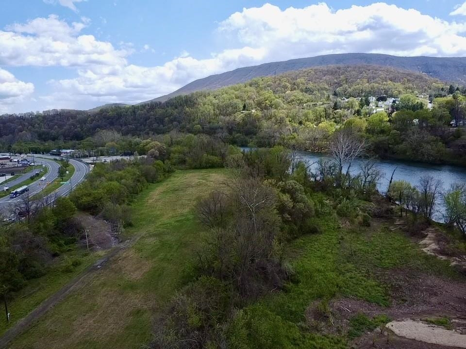 Exceptional investment opportunity in the heart of Narrows, VA. Spanning over 13 acres along HWY 460 Virginia Ave, this prime property boasts approximately 0.4 miles of picturesque New River frontage. Strategically positioned for maximum accessibility, it features three points of entry, including a spacious, pre-graveled parking area and a ramped access point at the traffic light, ideal for accommodating larger vehicles and trucks. Utility infrastructure is already in place, with electric service, a camper hookup, and dusk-to-dawn lighting. Endless possibilities for development or commercial use.