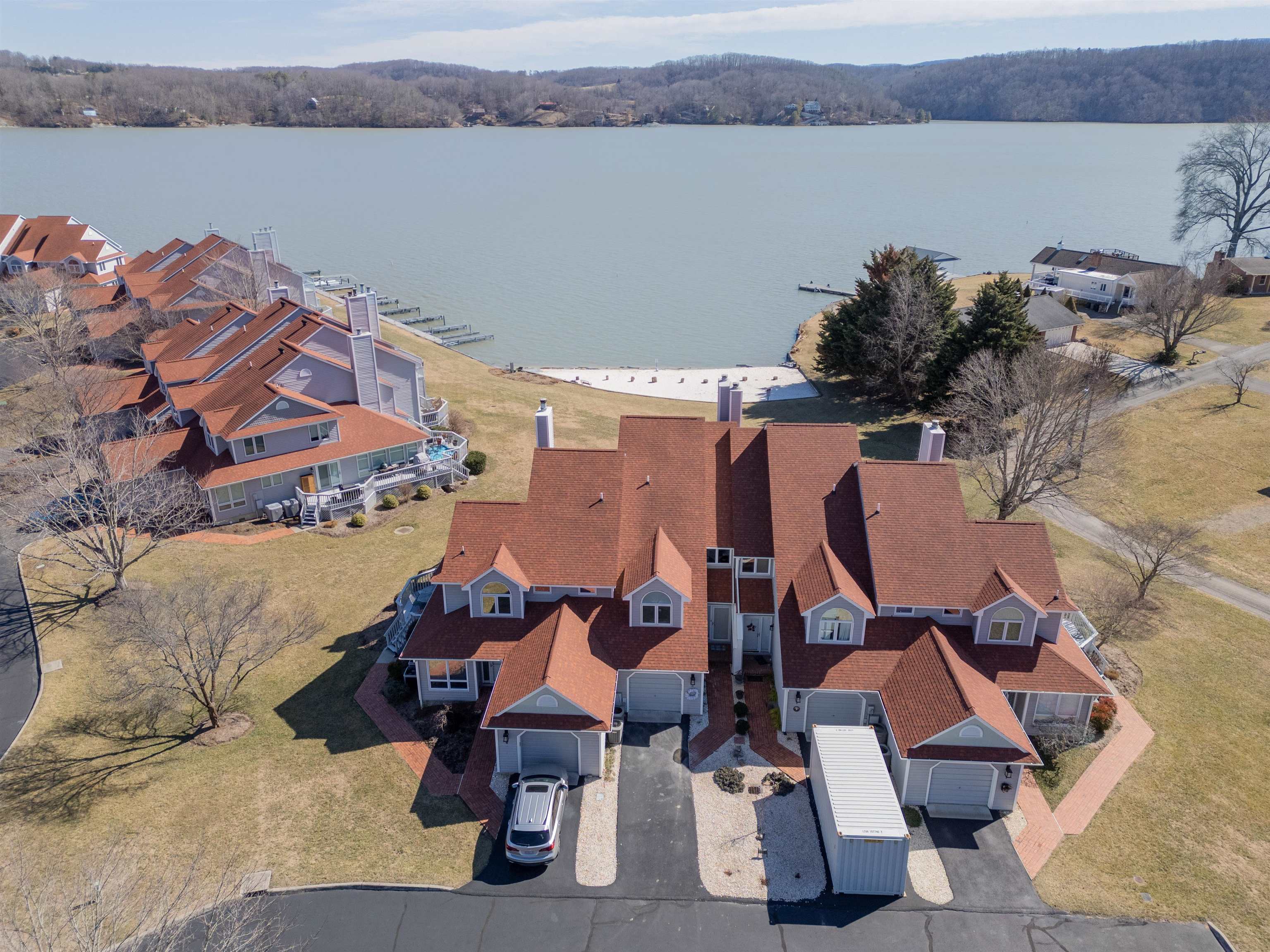 Enjoy lakeside living at its finest in this 3 bed, 3.5 bath condo in the desirable Mallard Point community on Claytor Lake. With private lake access and your own dock, it's perfect for boating, fishing, or relaxing by the water. Located next to the state park, this home offers nature’s beauty at your doorstep. The open-concept main level features a gourmet kitchen with solid surface countertops and stainless steel appliances, flowing into the living area with stunning lake views. The primary suite boasts a spa-like bath and walk-in closet. Two additional bedrooms with private baths offer comfort for guests. The finished basement provides extra living space with a separate kitchen, bathroom, and plenty of room for guests or family. Take advantage of the community amenities, while enjoying the convenience of local shops and dining. Don’t miss this opportunity for lakeside living!