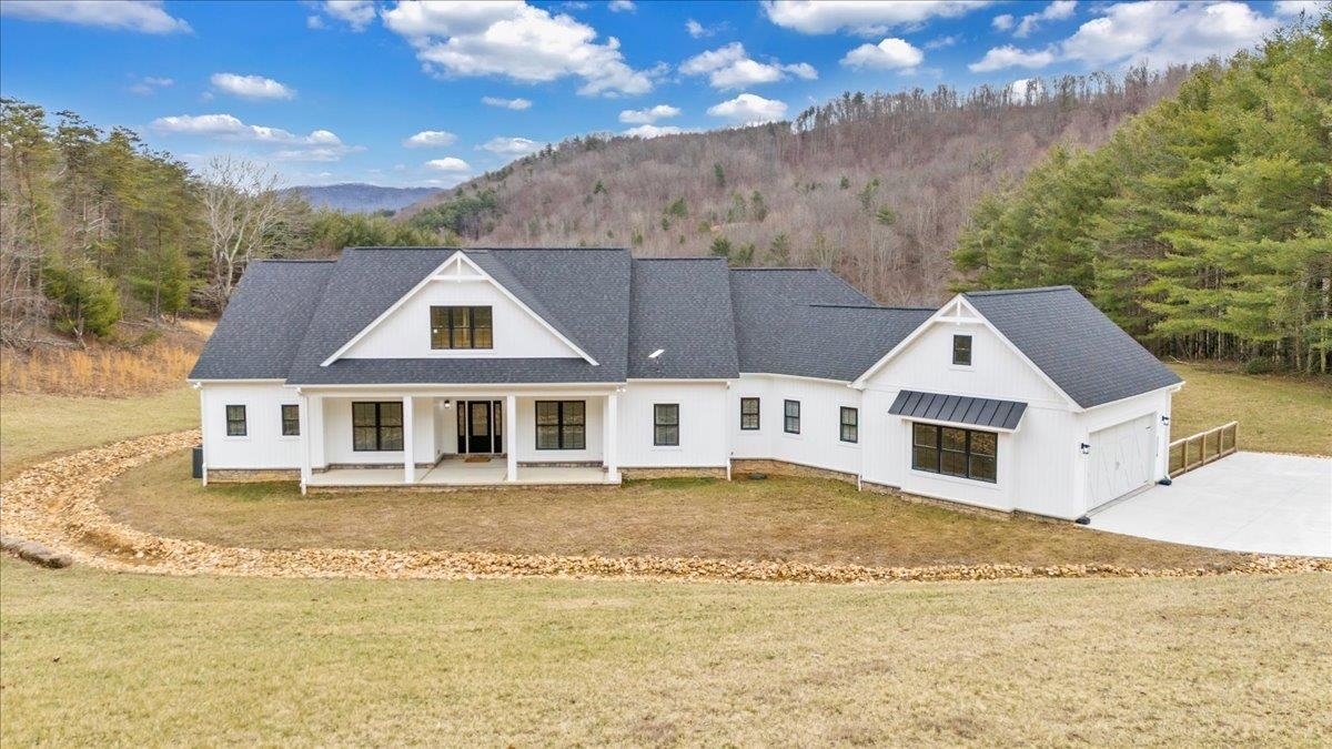 Nestled on a serene 31-acres, this stunning home, built in 2023, combines luxury with peaceful countryside living. The open floor plan features 4 spacious bedrooms, 3 full bathrooms, an office,2 half bathrooms, and an open rec room in the basement perfect for a gym or kids playroom. The kitchen boasts sleek granite countertops, high-end appliances, and ample cabinet space, flowing seamlessly into the living and dining areas—ideal for entertaining. Large windows throughout offer tons of natural light & beautiful views. The private master suite provides a luxurious en-suite bathroom, a soaking tub, a walk-in shower, and an enormous master closet. Two attached garages (one under) provide ample storage/parking. The home includes two whole home Generac generators. Outside, the property includes a Morton building with an apartment perfect for guests. The expansive land has a pond & is ideal for horse lovers or those looking to start a mini farm! Don't let this beautiful property slip away!