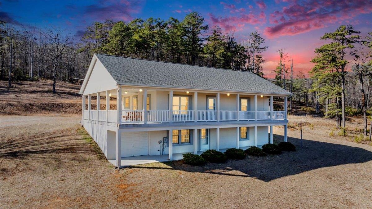 MOUNTAIN VIEWS you have to SEE to believe! If you want to live on top of the world, this 70 Acre property with wrap-around porch overlooking million-dollar views is for you. Impeccably maintained 2k+ sq ft home offers 2 upstairs bedrooms, 2 downstairs bedrooms, 3 full baths, finished basement with 2nd living space that is plumbed for a 2nd kitchen or wet bar. With an attached single garage, detached 2-car garage with its own electrical panel, poured concrete wall basement, metal stud construction, & durable stucco exterior finish, this home is where quality construction meets comfort. An amazing value-add is the 2nd potential building site on the 70 acres--higher up with another amazing view in a cleared, flat spot. The possibilities are endless. As you wake up to the sun rising over your mountain views, you'll feel like you're away from it all while actually being close to everything.With strong cell phone reception, beautiful home, & million-dollar views, you can have it all.