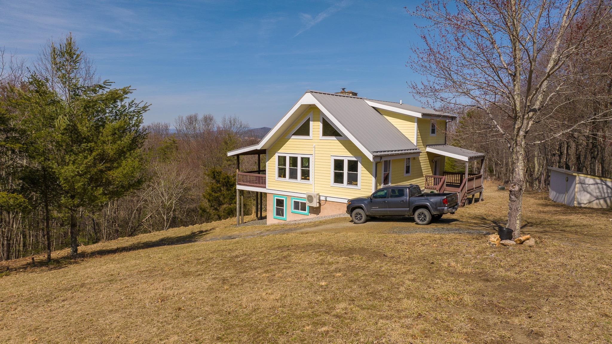 A Floyd County VA stunning Blue Ridge Mountain retreat. A beautiful custom home with long range views, high speed internet, seclusion but still close to town. This two bedroom house is just the right size. This 64 acres (63.99 to be exact) has Loss Bent Creek on it with beautiful hardwoods and conifer forest. Abundant wildlife and rural seclusion make this farm a real gem. There is garden space and beautiful orchards with pear, apple, persimmon, grapes and nut trees. The long range views are breathtaking and this property is ready for someone to make it their own. The covered porch off the living room welcomes you to sit down and let the world go by as you gaze upon the beautiful Blue Ridge Mountains. The acreage is in 4 tracts.